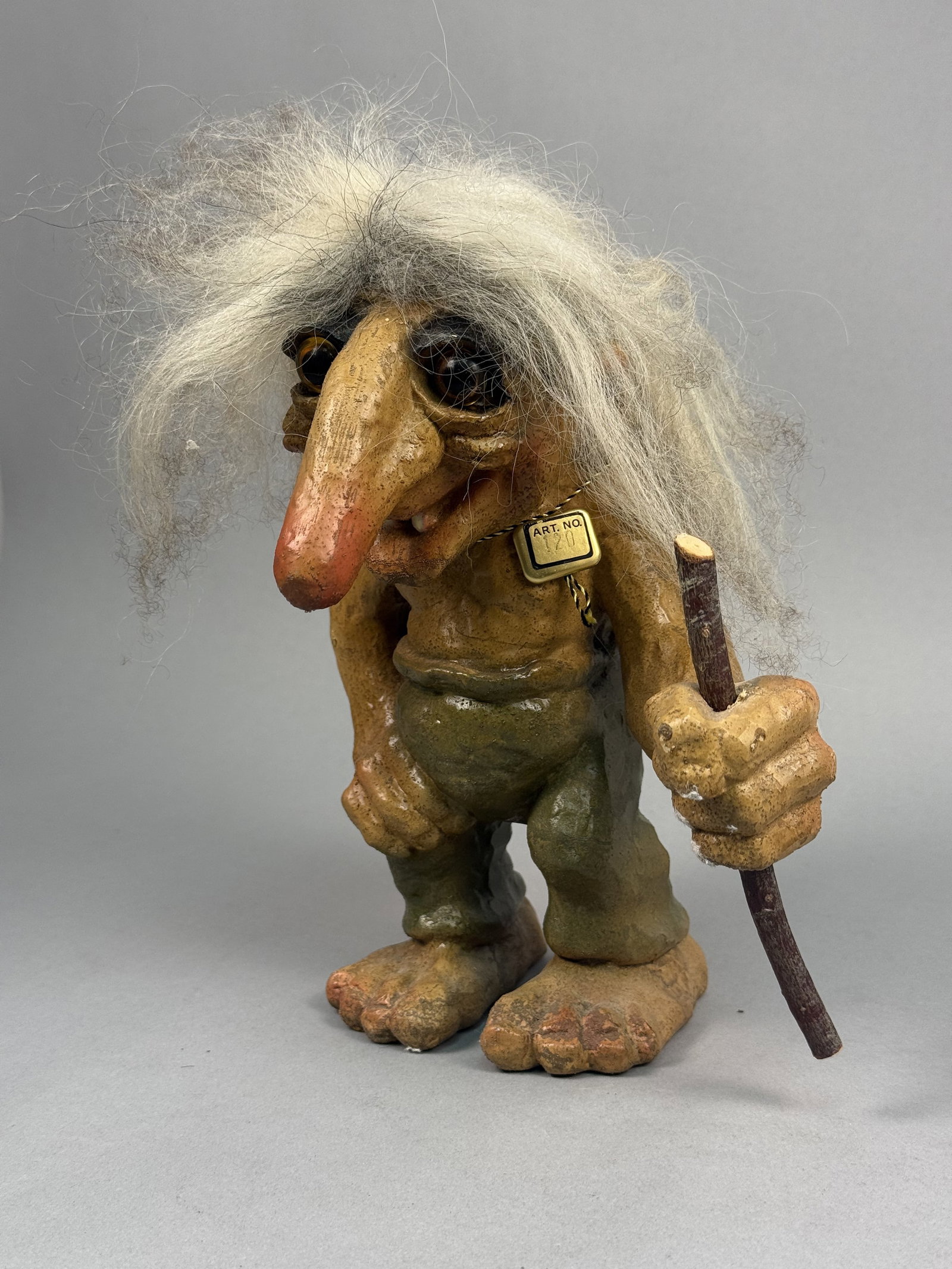 NyForm Norway Troll Number 120: A large NyForm troll figurine featuring a molded latex body with a hand-finished textured surface and dark green pants. The figure is characterized by a long bulbous nose, inset amber-colored eyes,