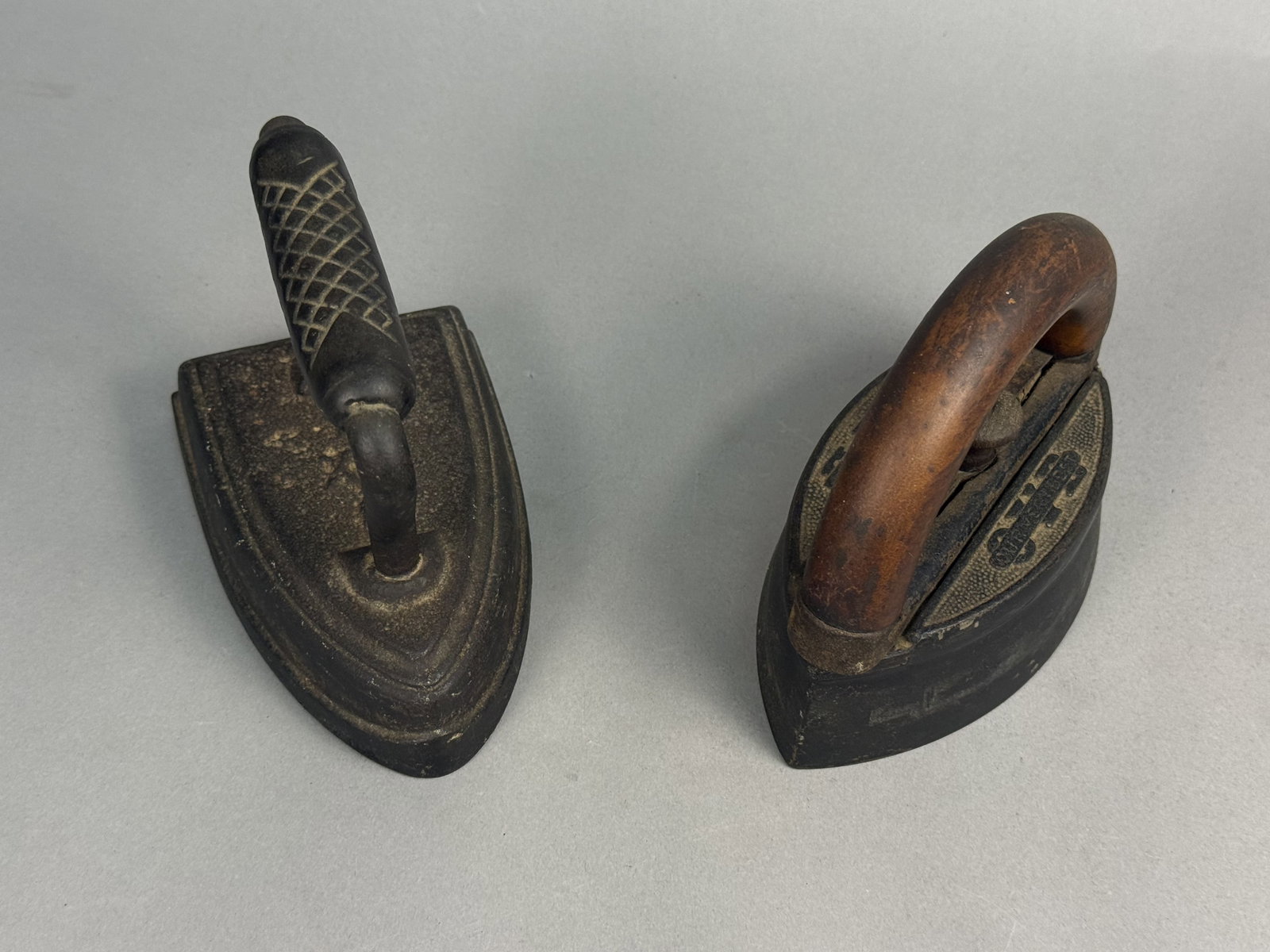 Two Antique Cast Iron Sad Irons: This lot features a Hibbard, Spencer, Bartlett & Co. detachable handle iron and a solid cast sad iron. The interchangeable base is embossed with the Our Very Best trademark and a number 9, finished