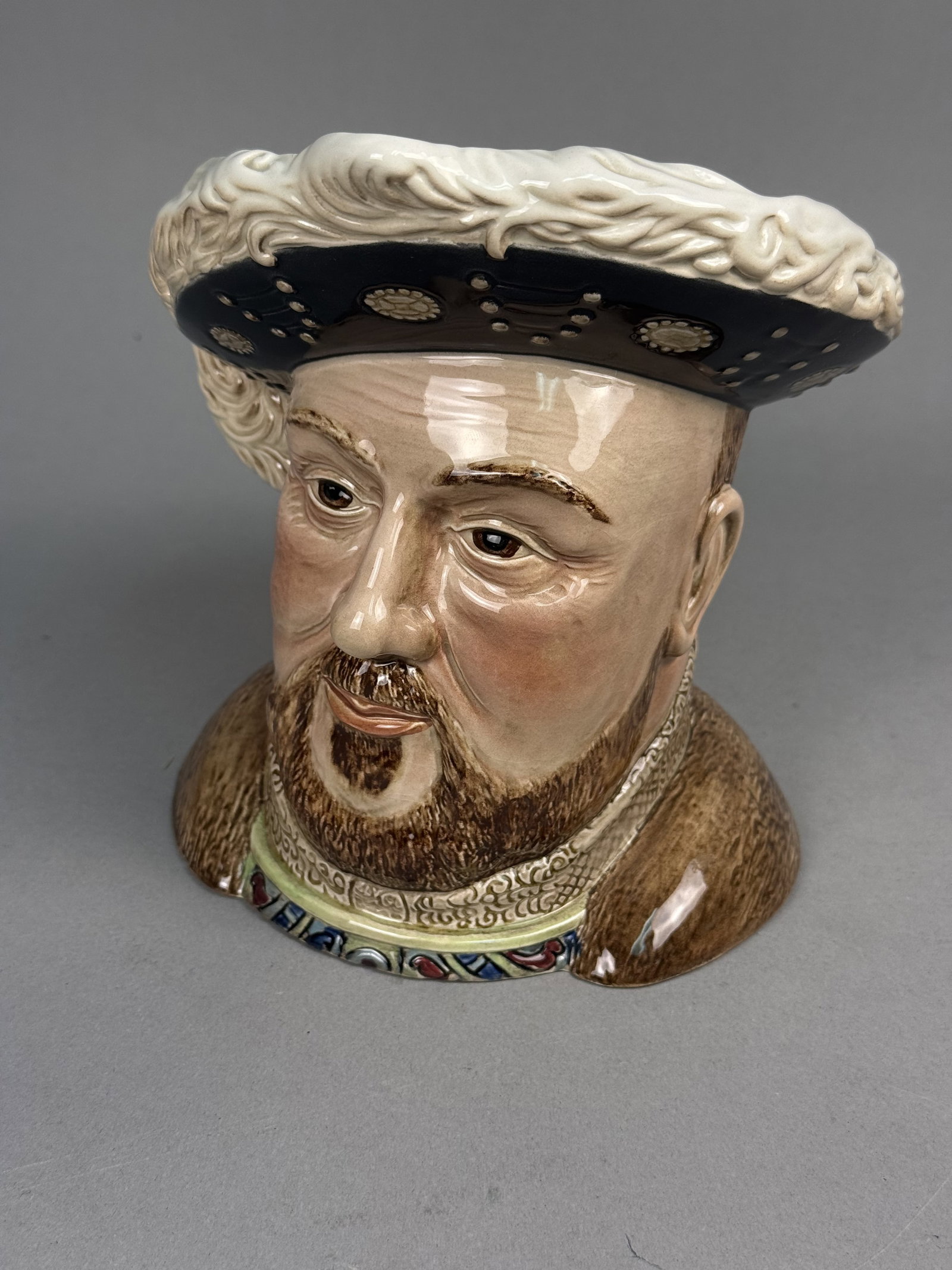 Beswick Henry VIII Character Jug: This large Beswick glazed ceramic character jug, model number 2099, depicts King Henry VIII in a plumed Tudor hat and fur-trimmed cloak. The figure is intricately modeled with an ornate lace collar