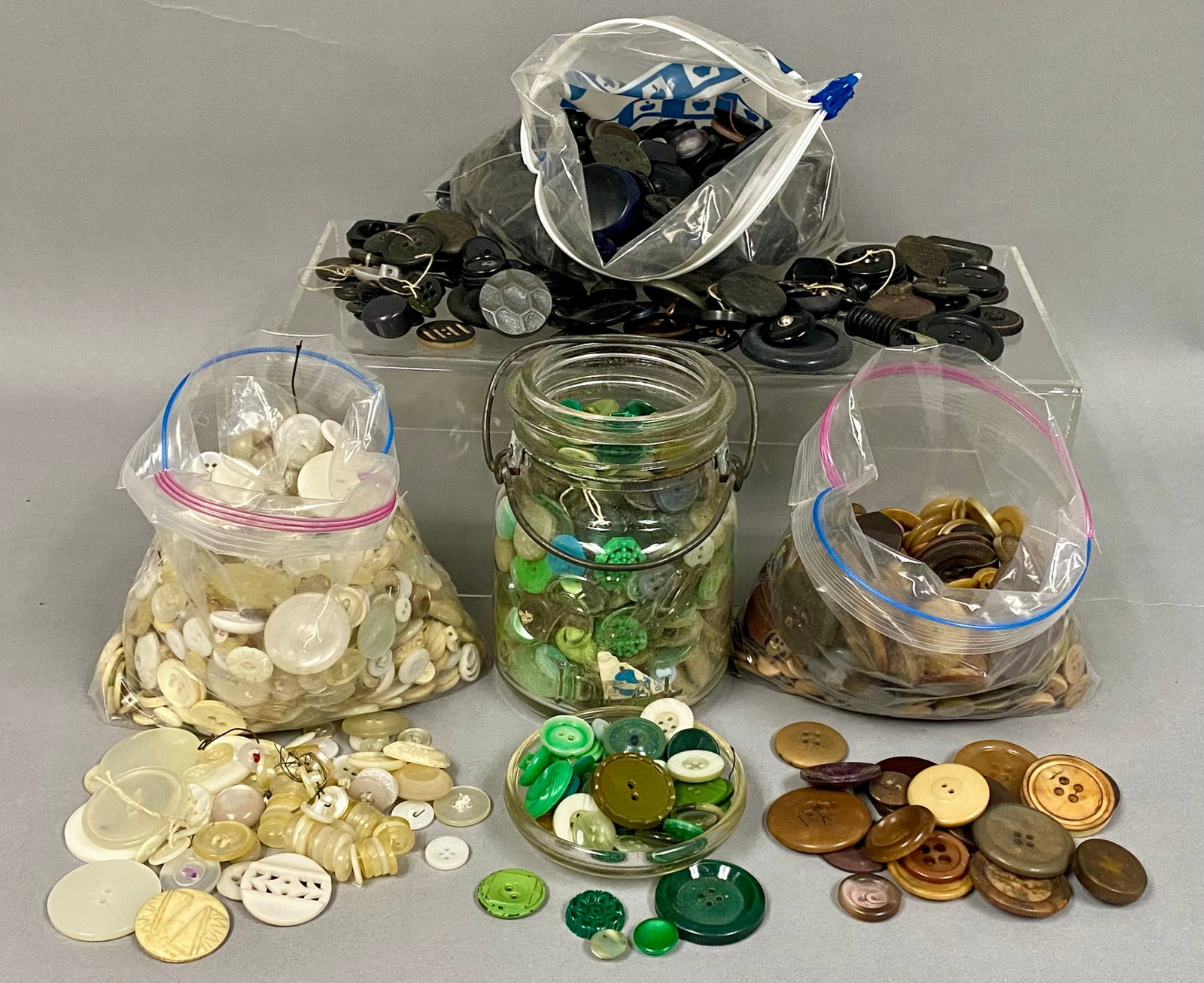 Vintage Button Collection and Ideal Jar: This expansive estate collection consists of hundreds of vintage buttons dating from the early to mid-20th century. Materials include mother-of-pearl, milk glass, and early plastics such as celluloid,