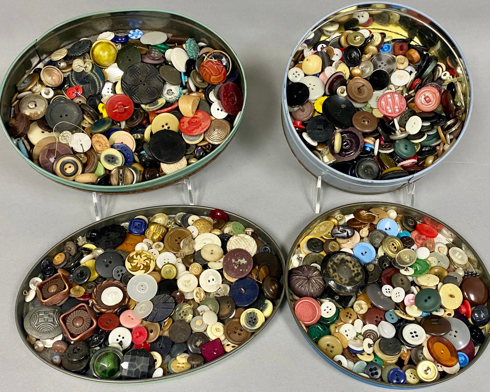 Large Collection of Vintage Buttons: This lot features a diverse assortment of vintage garment buttons housed in two painted metal tins. The vast collection includes examples in materials such as mother-of-pearl, carved celluloid, glass,