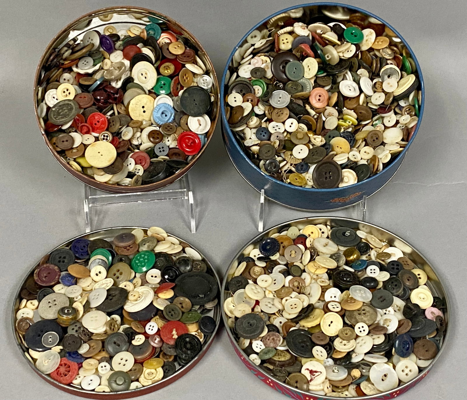 Large Collection of Vintage Buttons: An assortment of vintage and antique buttons housed in two decorative metal tins. The collection features a variety of materials including mother-of-pearl, bone, wood, metal, and various early plastic