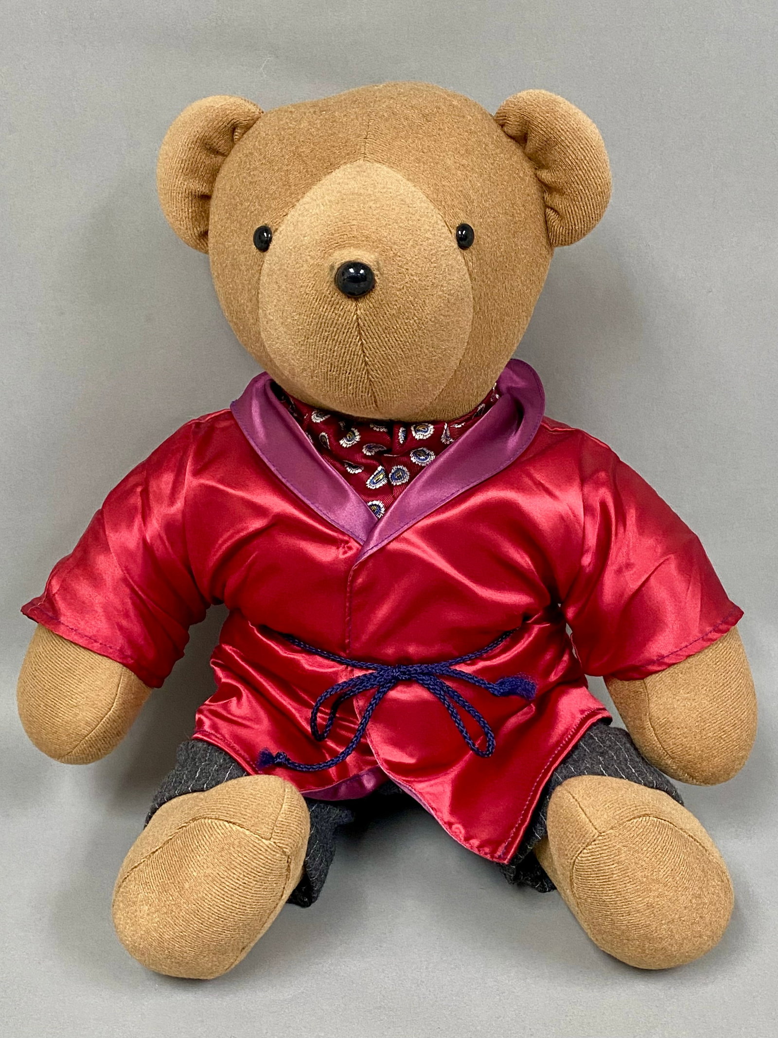 North American Bear Co Hugh Heifer: North American Bear Co. V.I.B. Hugh Heifer plush teddy bear, dated 1979. The tan plush bear is dressed in a red satin dressing gown with purple lapels, a paisley cravat, and pinstriped fabric trousers
