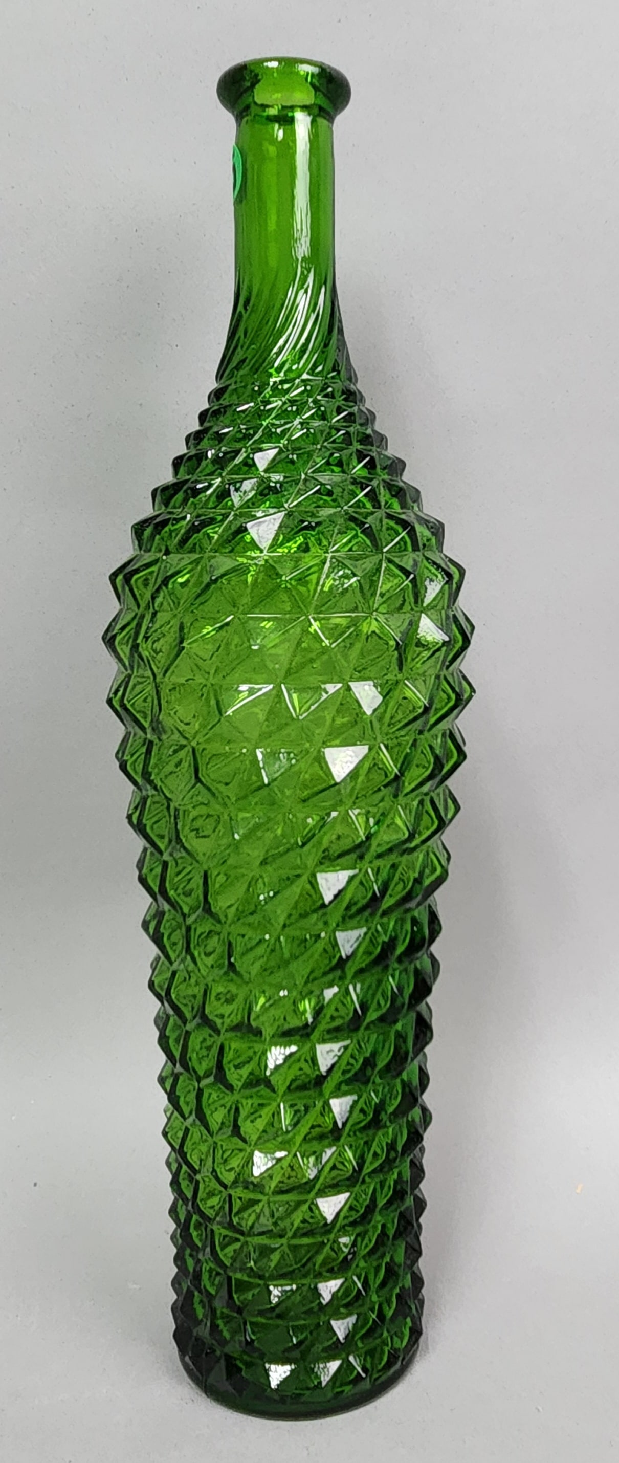 Empoli Green Diamond Point Bottle: This vintage emerald green pressed glass bottle features the iconic diamond point pattern characteristic of Italian production from Empoli. Height: 15.5 inches. Excellent vintage condition with no vis