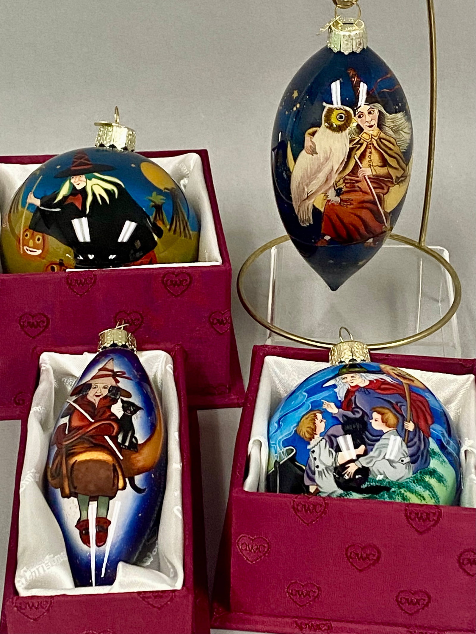4 OWC Halloween Glass Ornaments: This set of four Old World Christmas (oWC) glass ornaments features interior reverse-painted Halloween scenes including witches, pumpkins, and black cats. The collection consists of two spherical and 