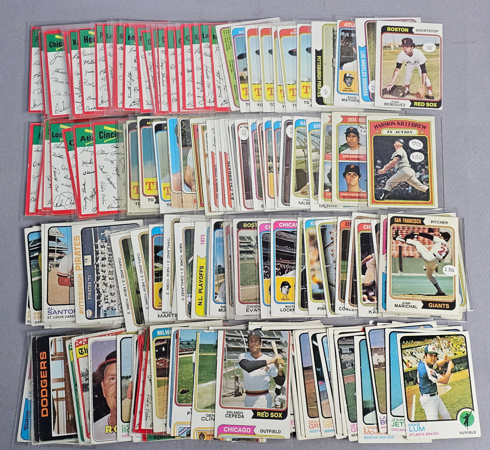 Assortment of 1970s Topps Baseball Cards: This collection of Topps baseball cards spans the early 1970s, including issues from 1970, 1972, 1973, and 1974. The lot features a variety of subsets such as 1974 team signature checklists, league