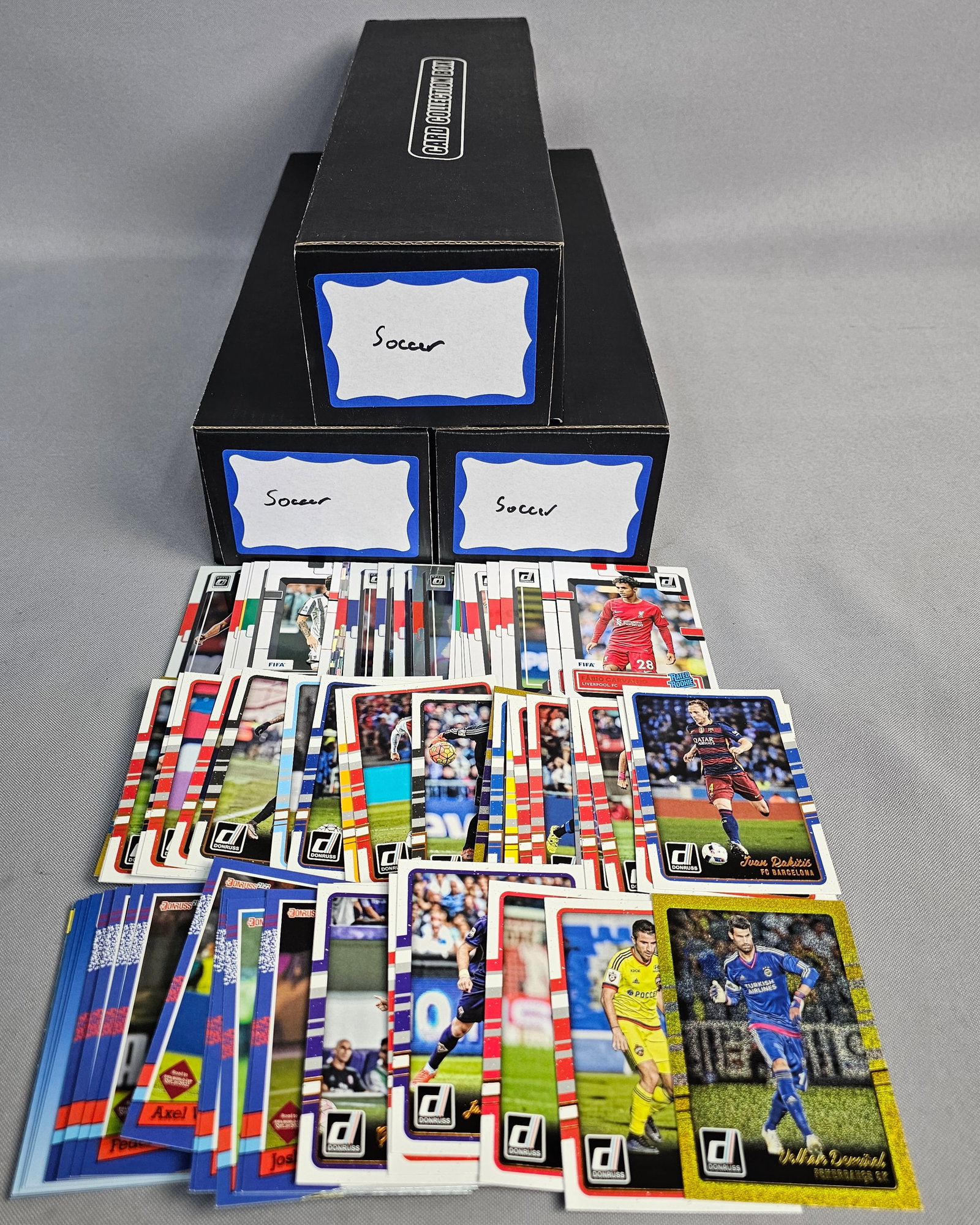 Large Panini and Topps Soccer Card Collection: This bulk collection of soccer trading cards comprises of items from manufacturers including Panini and Topps. Featured series include Panini Prizm Premier League, Panini Donruss Road to FIFA World