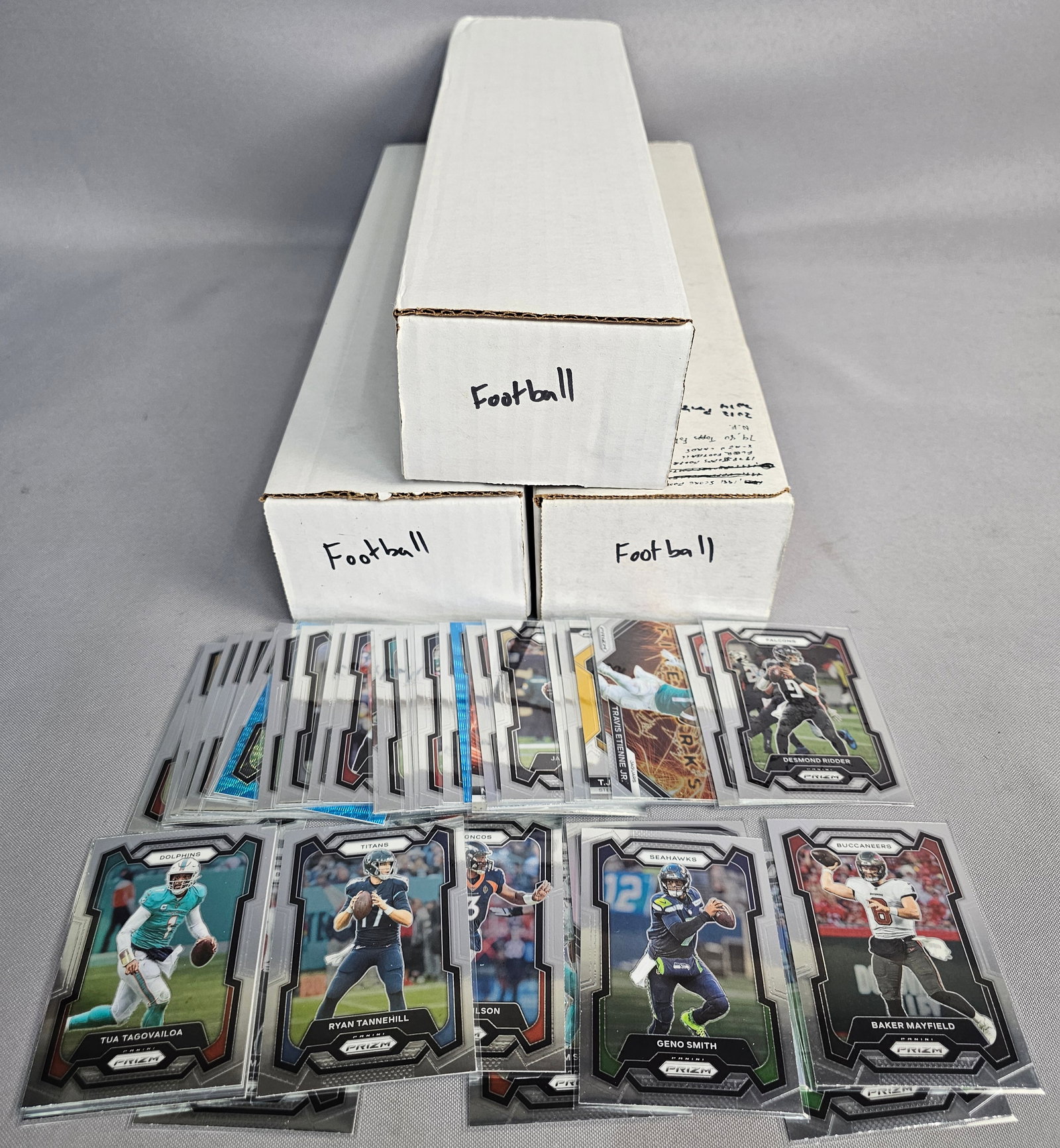 Extensive Football Card Collection: This large collection of American football trading cards includes items housed in three standard storage boxes, featuring sets from Panini Prizm, Panini Absolute, and vintage Topps. Notable players