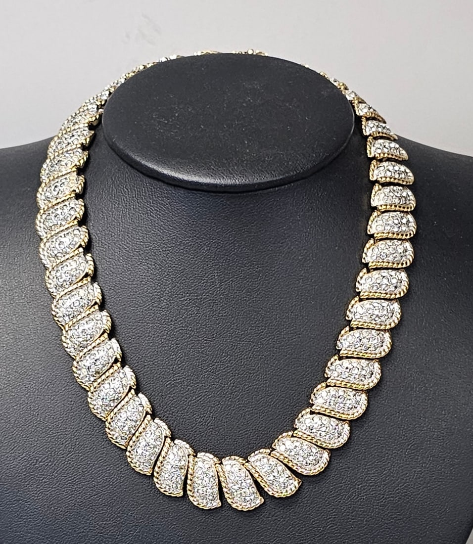Carolee Gold-Tone Rhinestone Collar Necklace: This gold-tone collar necklace by Carolee features a bold mid-century design with textured rope borders and pav?©-set clear rhinestones. The piece measures approximately 16 inches in length with indi