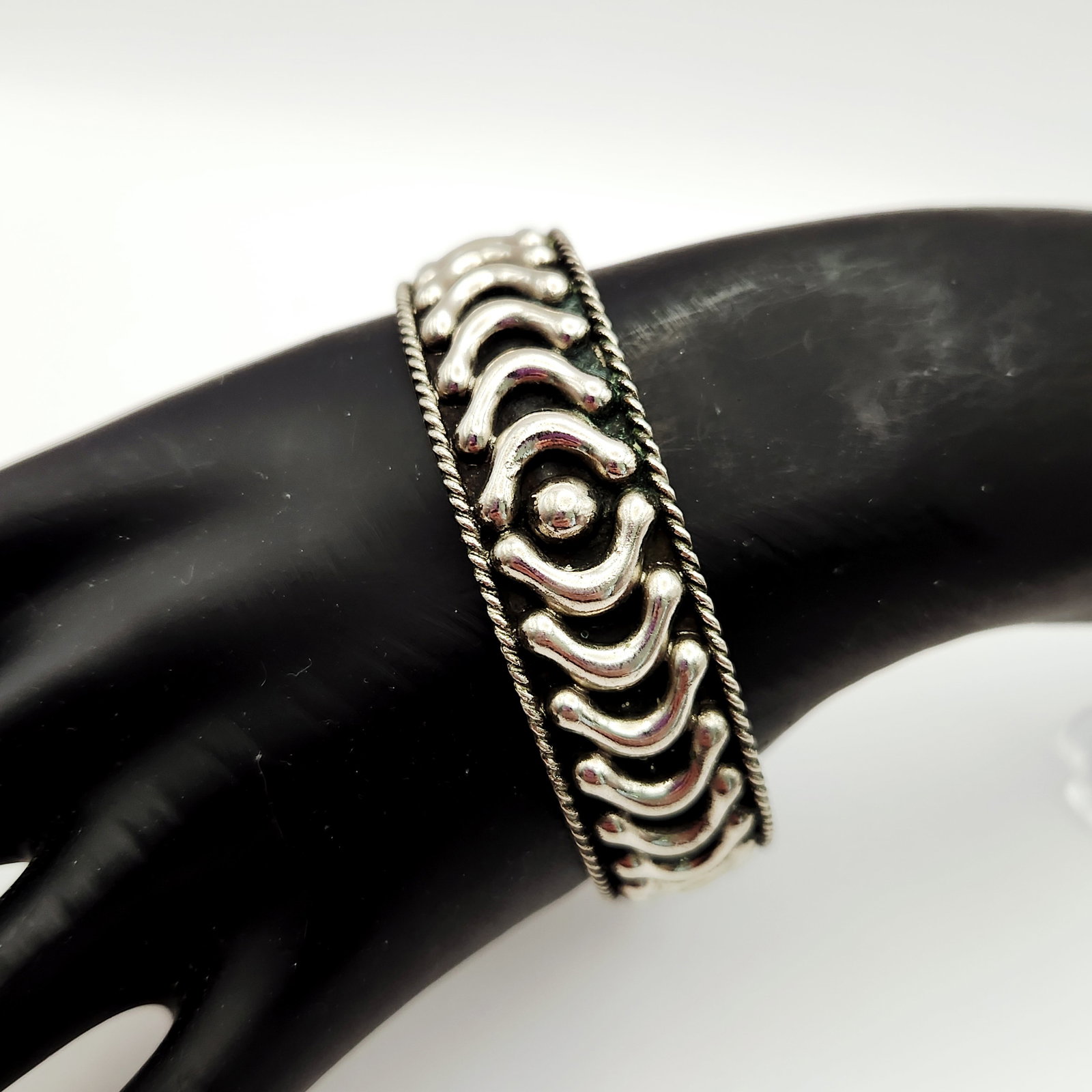 Vintage Mexican Alpaca Cuff Bracelet: This vintage Mexican cuff bracelet is crafted from Alpaca, a silver-toned metal alloy containing copper, nickel, and zinc. The interior of the band is stamped ALPACA and MEXICO. Band width: 1 inch.