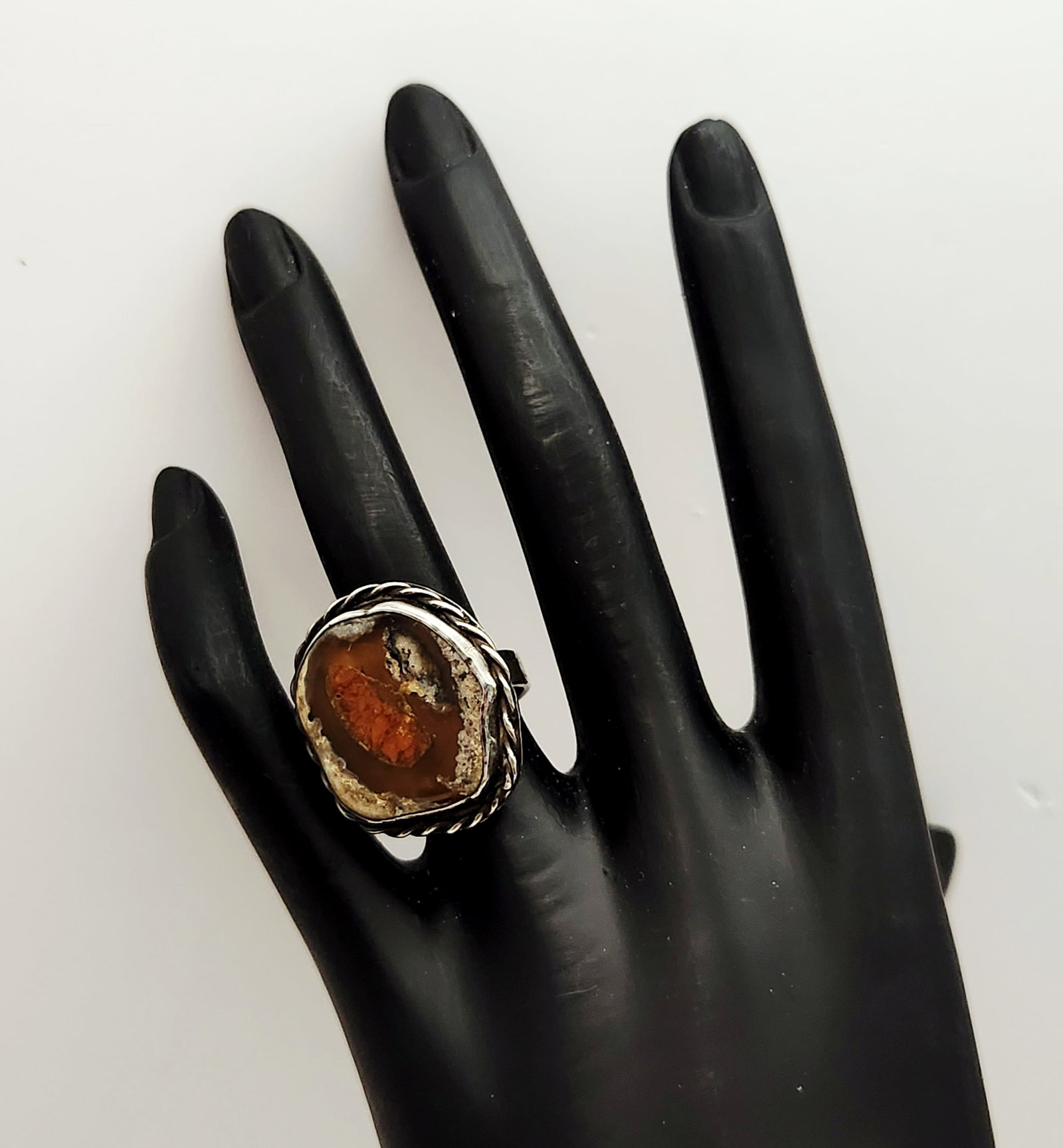 Sterling Fire Agate Ring 9.3 Grams: This Southwestern style statement ring is crafted in sterling silver and features a large, freeform fire agate cabochon secured in a bezel setting. The interior of the band is stamped vertically with 