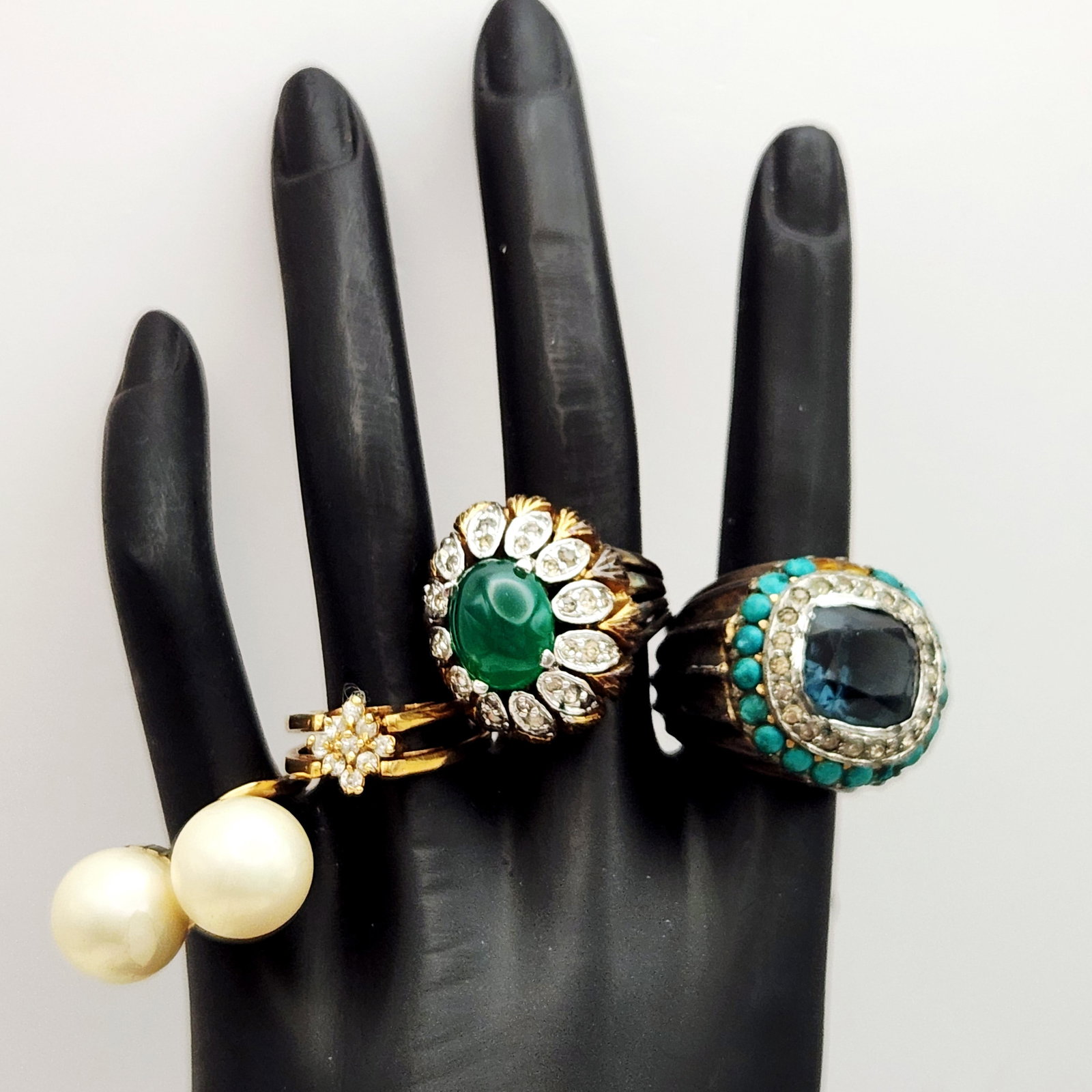 Assortment of Fashion Rings: This collection comprises four fashion rings, including a cushion-cut blue stone ring with turquoise-colored halos set on a ribbed oxidized silver-toned band. Sizes: 5.5 to 7.5. The items exhibit