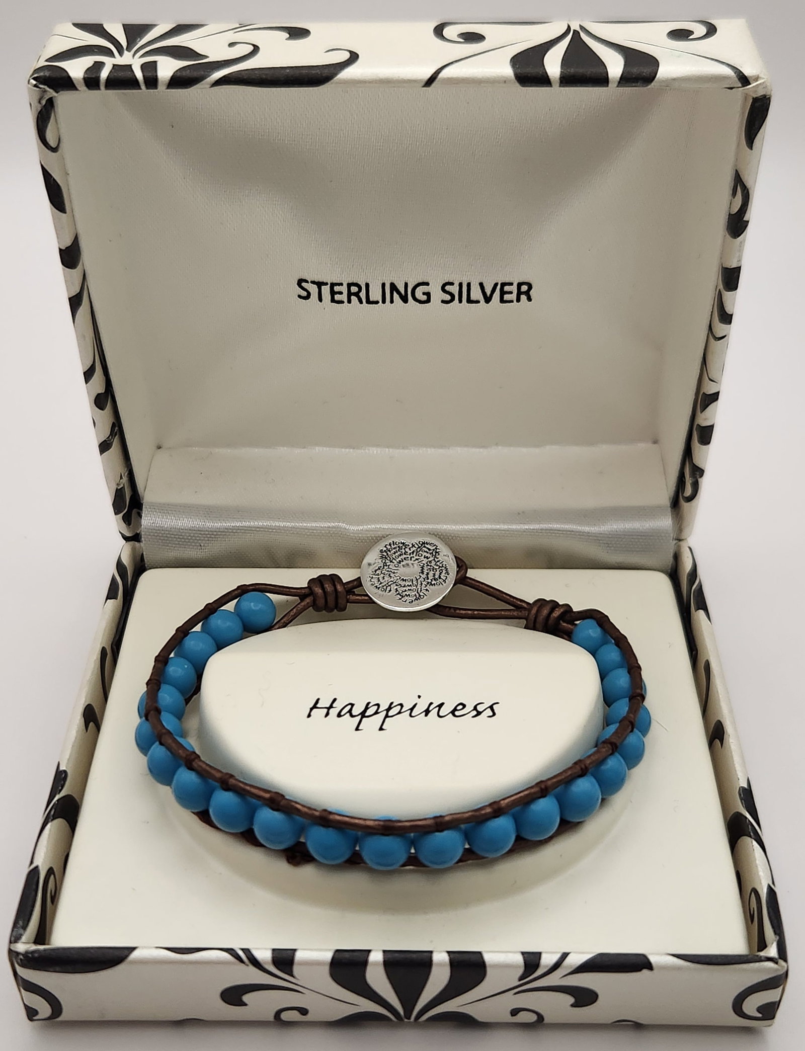 Sterling Blue Bead Wrap Bracelet: This single-wrap leather bracelet features approximately 22 matte blue beads hand-woven between strands of brown leather cord. sert. Total length: 7.5 inches The bracelet is in excellent condition,