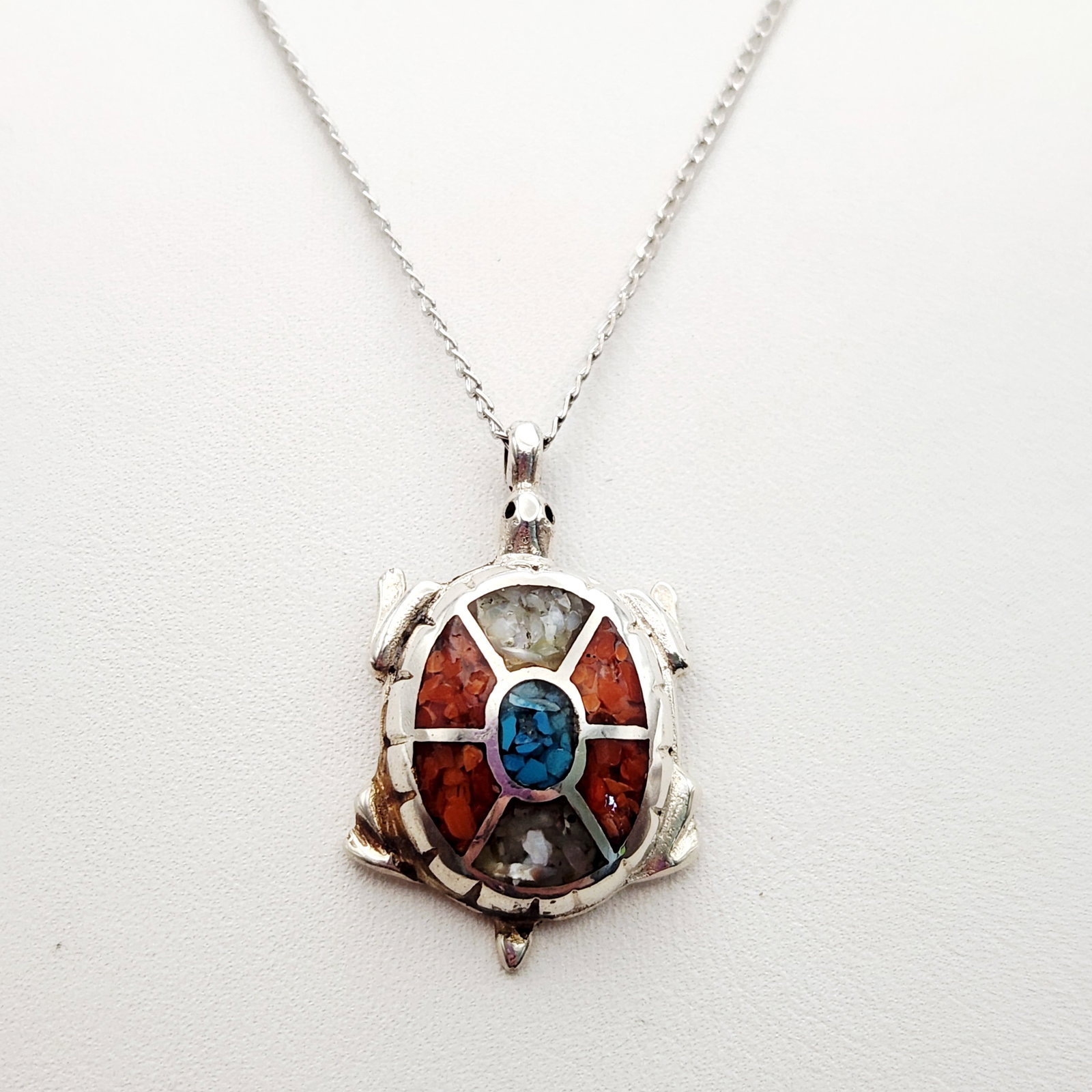 Silver Tone Turtle Inlay Necklace: This 16-inch sterling silver chain features a turtle pendant decorated with a multi-stone chip inlay of turquoise, jasper, and shell. The Italian curb-link chain is stamped 925. Good vintage condition