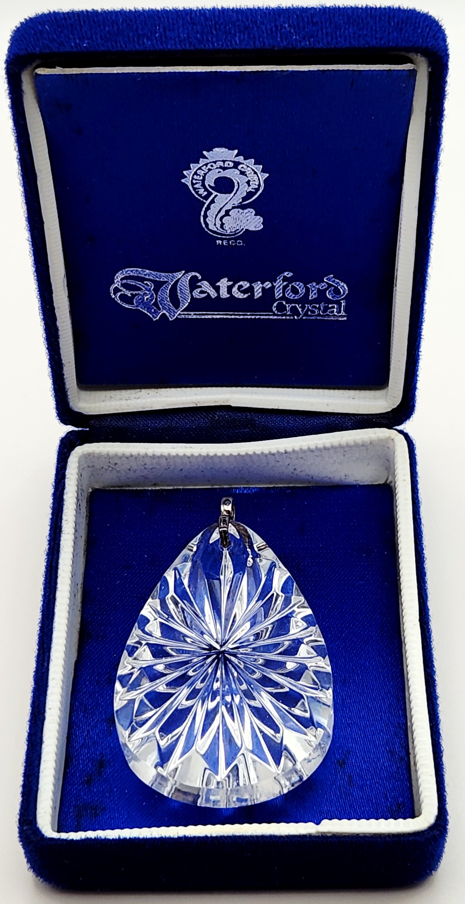 Waterford Crystal Teardrop Pendant: A faceted lead crystal pendant featuring a pear-shaped form with a deeply cut radial starburst pattern on the reverse side. Length: 2 inches. The crystal is in excellent condition with no visible chip
