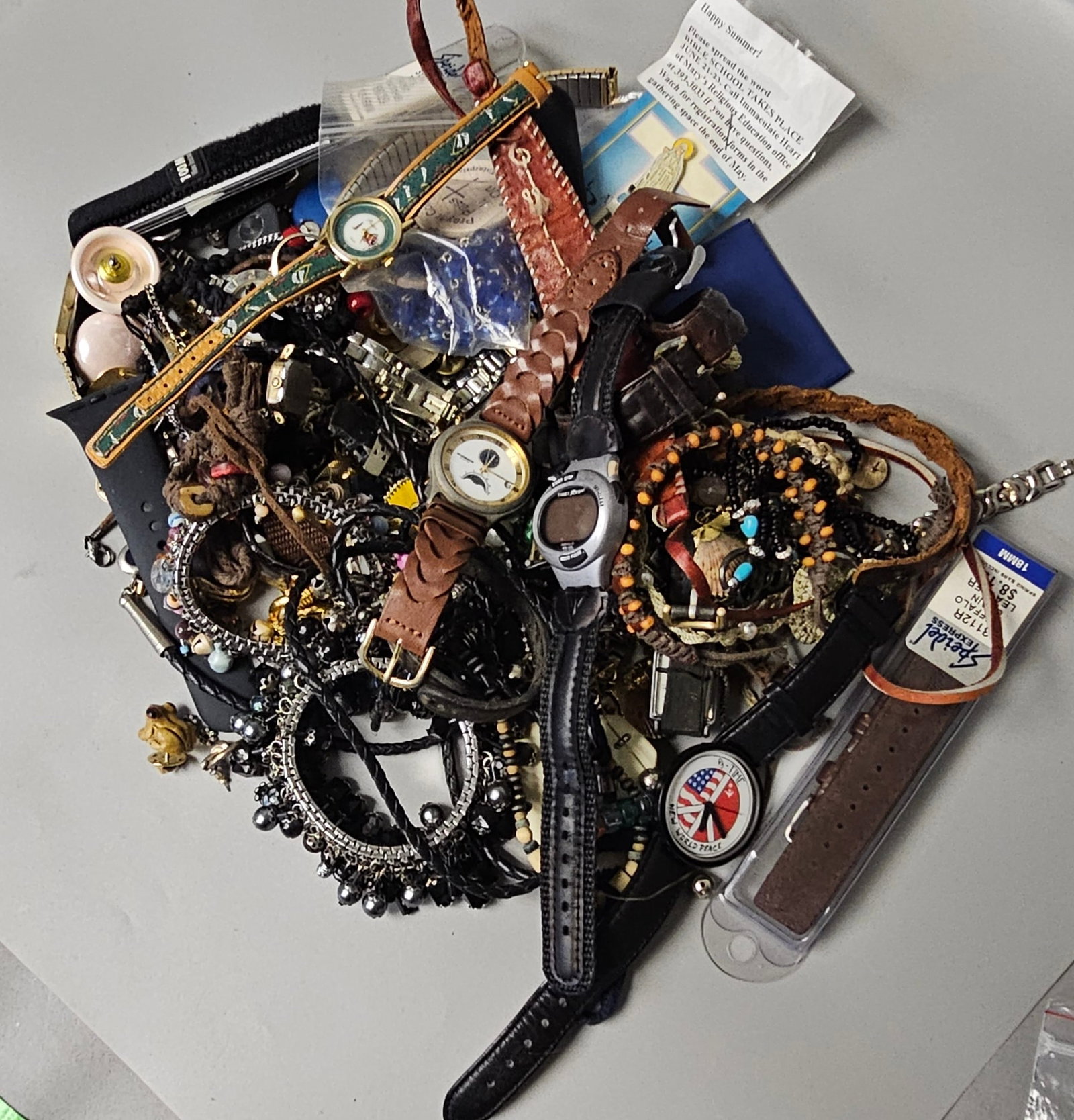 Assorted Wristwatches and Fashion Jewelry Lot: This collection features various wristwatches from makers including Fossil, Timex, and McGregor, highlighted by a moon-phase dial and a New World Peace themed timepiece. The lot is rounded out by a