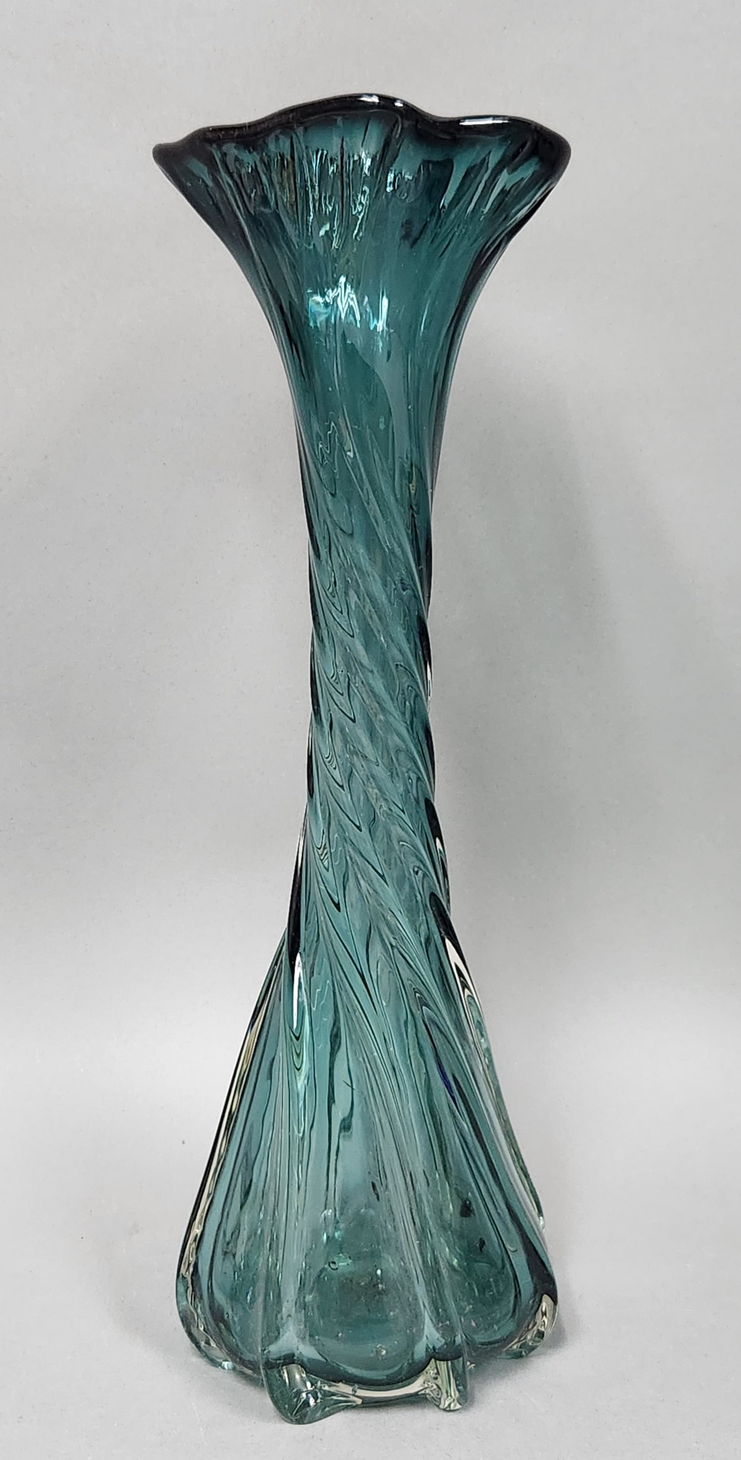 Mid-Century Swung Glass Vase: A hand-blown mid-century modern swung glass vase featuring a twisted ribbed body. A circular recessed pontil mark is visible on the underside of the heavy base. Height: 16.25 inches. This vase is in