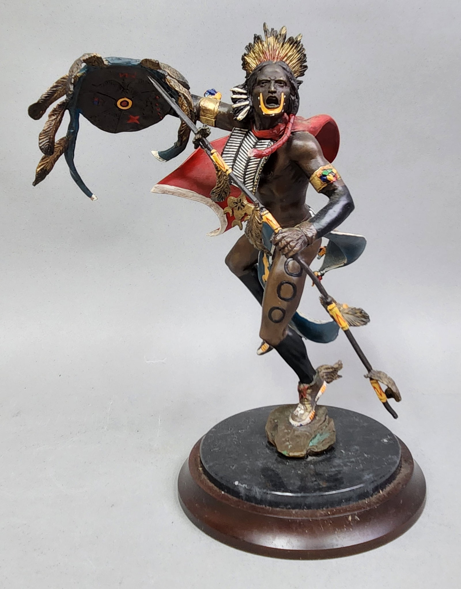 Franklin Mint Spirit of the Hawk: A Franklin Mint Spirit of the Hawk hand-painted cold-cast sculpture designed by R. J. Murphy. Height: 12 inches. The item is in good condition. Minor paint loss is visible on the red cape, and the