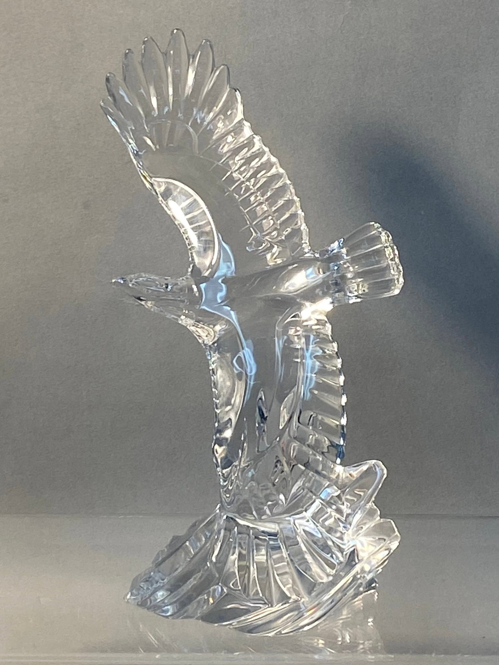 Lenox Soaring Majesty Crystal Eagle: This clear crystal eagle figurine is titled Soaring Majesty and was produced by Lenox in 1994. The bird is modeled in a dynamic soaring posture with its wings spread wide,one elevated and one swept