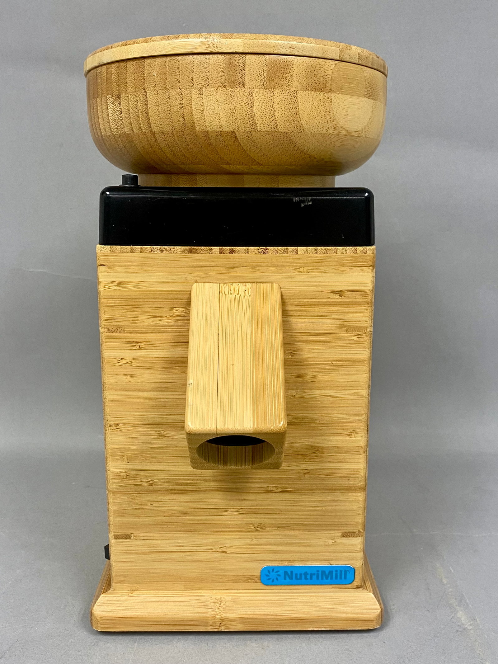 NutriMill Bamboo Harvest Grain Mill: This electric NutriMill Harvest grain mill is constructed with a laminated bamboo housing and features corundum-ceramic grinding stones. The design consists of a square base with an integrated