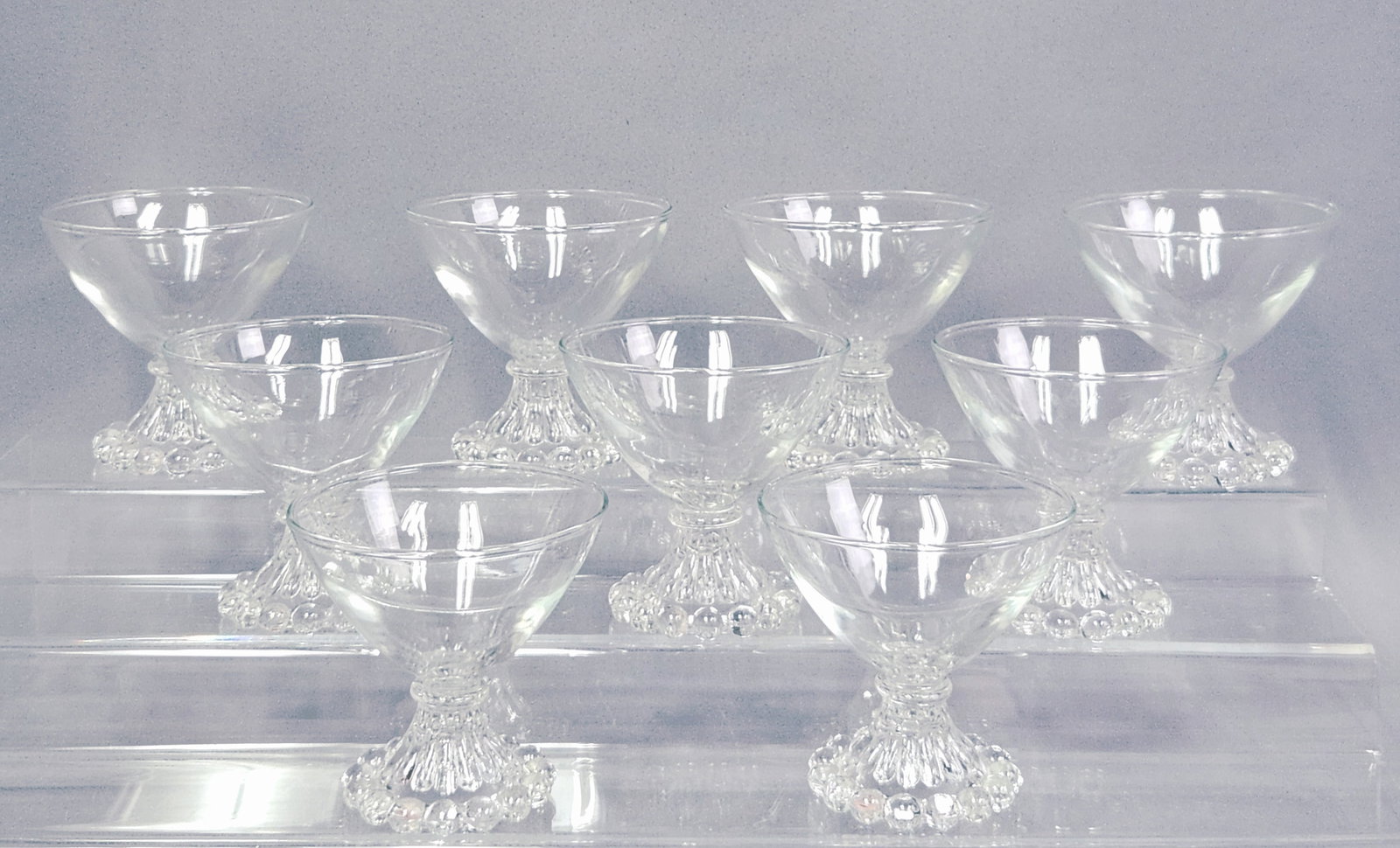 Anchor Hocking Boopie Sherberts Desert: A set of nine clear pressed glass dessert glasses. Height: 3.75 inches The glasses are in good vintage condition. No visible chips, cracks, or repairs are present on the bowls or the delicate beaded