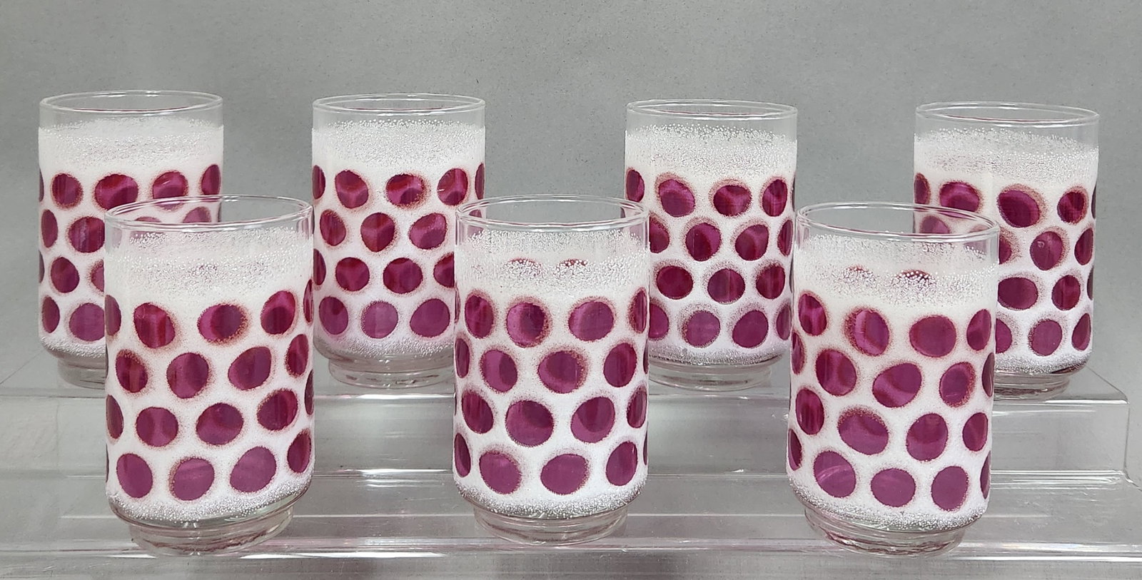 Libbey Concord Cranberry Coin Dot Tumblers: A set of mid-century Libbey drinking glasses featuring clear glass bodies decorated with a broad, textured white frosted band around the center. Height: 4.75 inches The glasses are in excellent