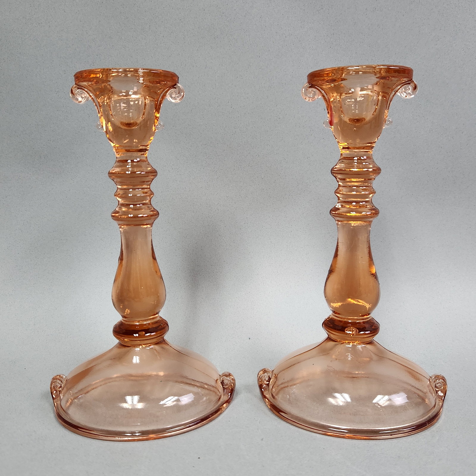 2 Paden City Scroll Pink Glass Candlesticks: A matched pair of Depression-era pink glass candlesticks in the Scroll pattern, cataloged as Line 191 by the Paden City Glass Manufacturing Company. Both candlesticks are unmarked, which is typical