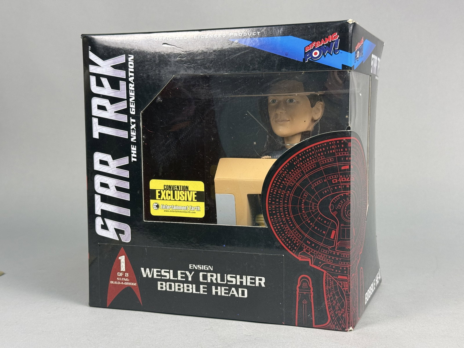 Bif Bang Pow! Wesley Crusher Bobblehead Exclusive: A 2013 Bif Bang Pow! bobblehead figure depicting Ensign Wesley Crusher from Star Trek: The Next Generation. This item is the first installment of an eight-piece Build-A-Bridge series and is identified