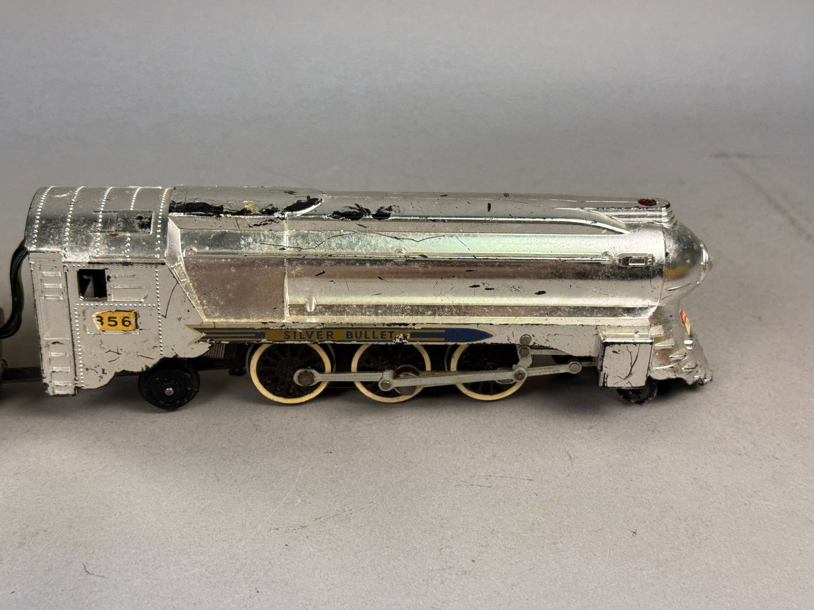 American Flyer Silver Bullet Locomotive: American Flyer 356 Silver Bullet streamlined steam locomotive with matching tender. The locomotive features a die-cast metal body and the tender is made of pressed steel, both finished in chrome plati