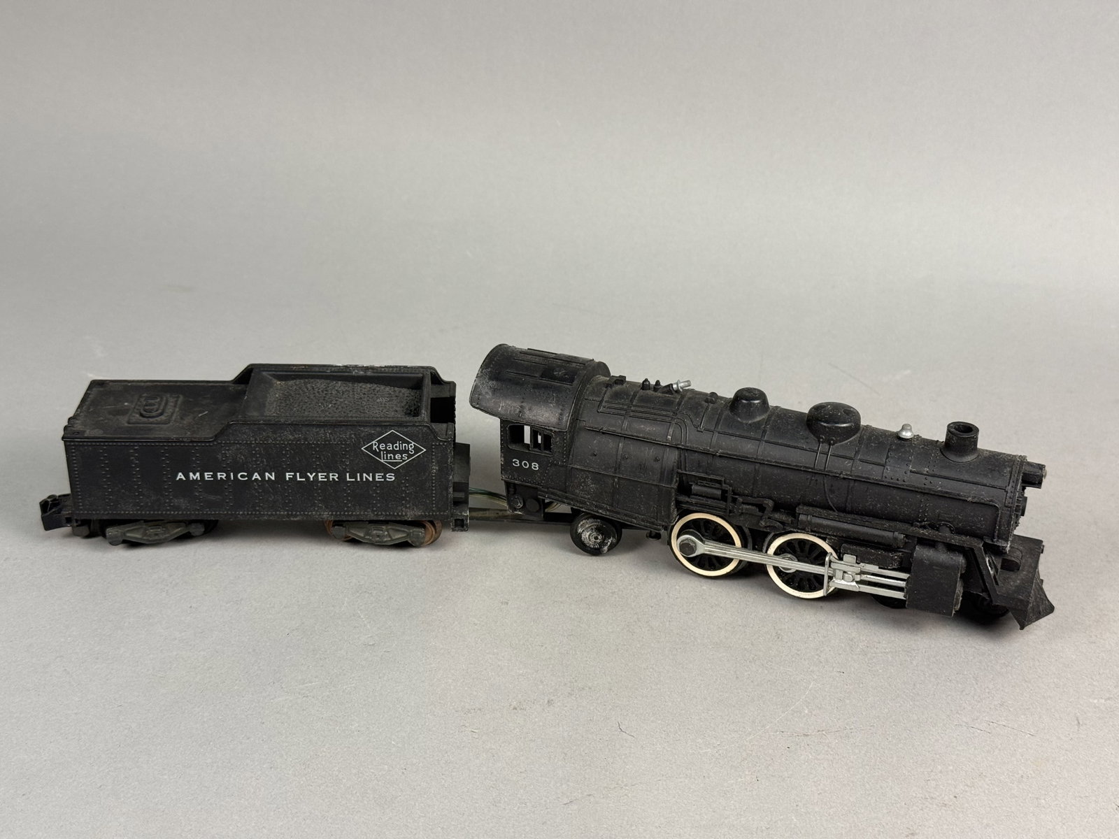 American Flyer 308 Atlantic Locomotive: An American Flyer S-gauge model train locomotive and tender set produced by the A. C. Gilbert Company. The locomotive cab side displays the number 308, and the tender is marked with Reading Lines and 