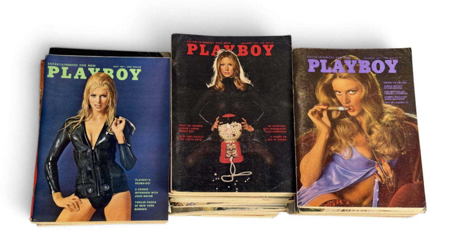 A Collection of 1970s Playboy Magazines: This lot comprises a large collection of vintage Playboy magazines dating from 1970 to 1973. The publications include significant content such as interviews with John Wayne and Jack Anderson, alongsid