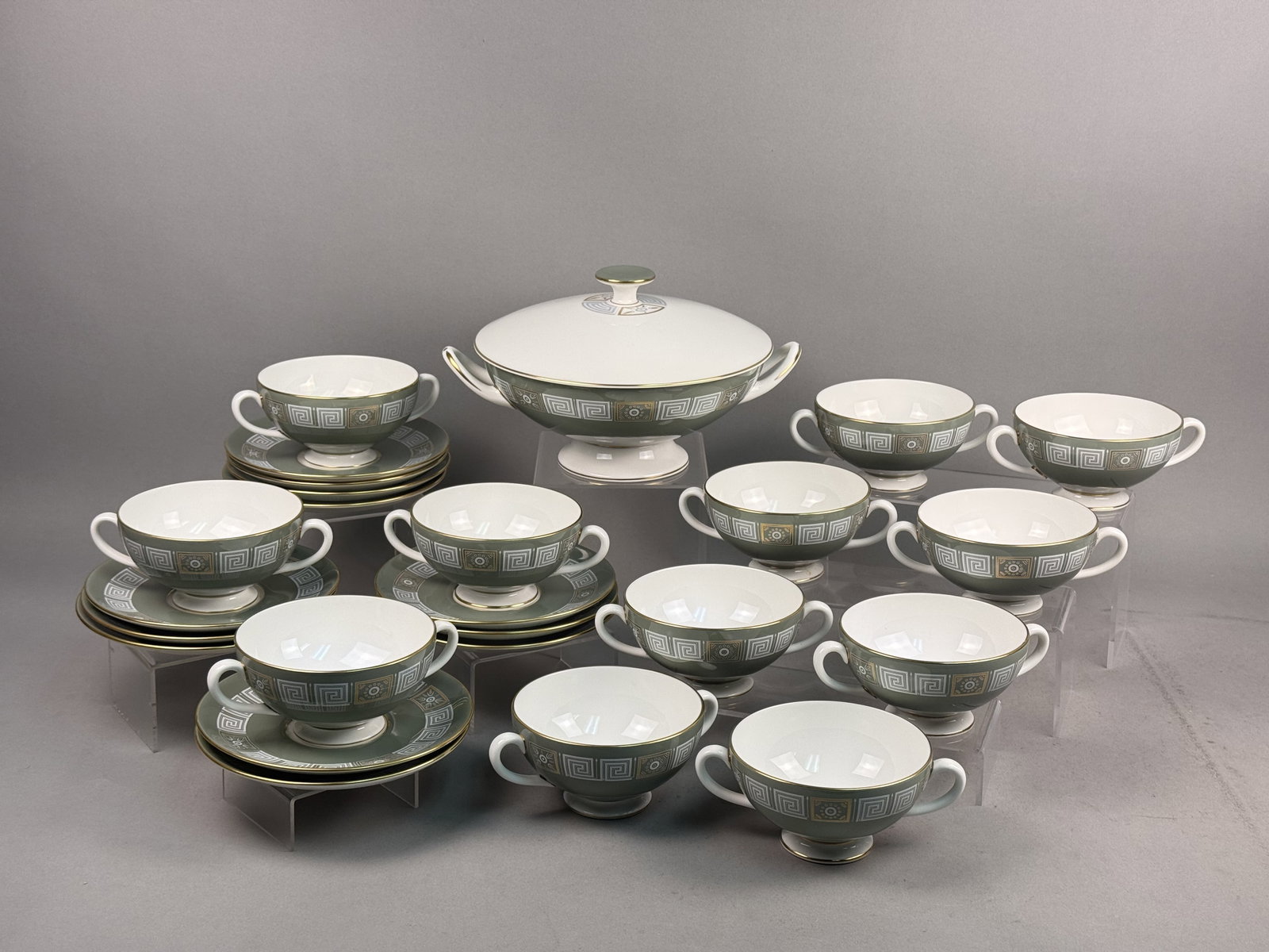 Wedgwood Asia Bone China Service: A Wedgwood fine bone china soup service in the Asia pattern, featuring a sage green ground with white Greek key borders and gilded decorative panels. The service comprises one lidded tureen, twelve do