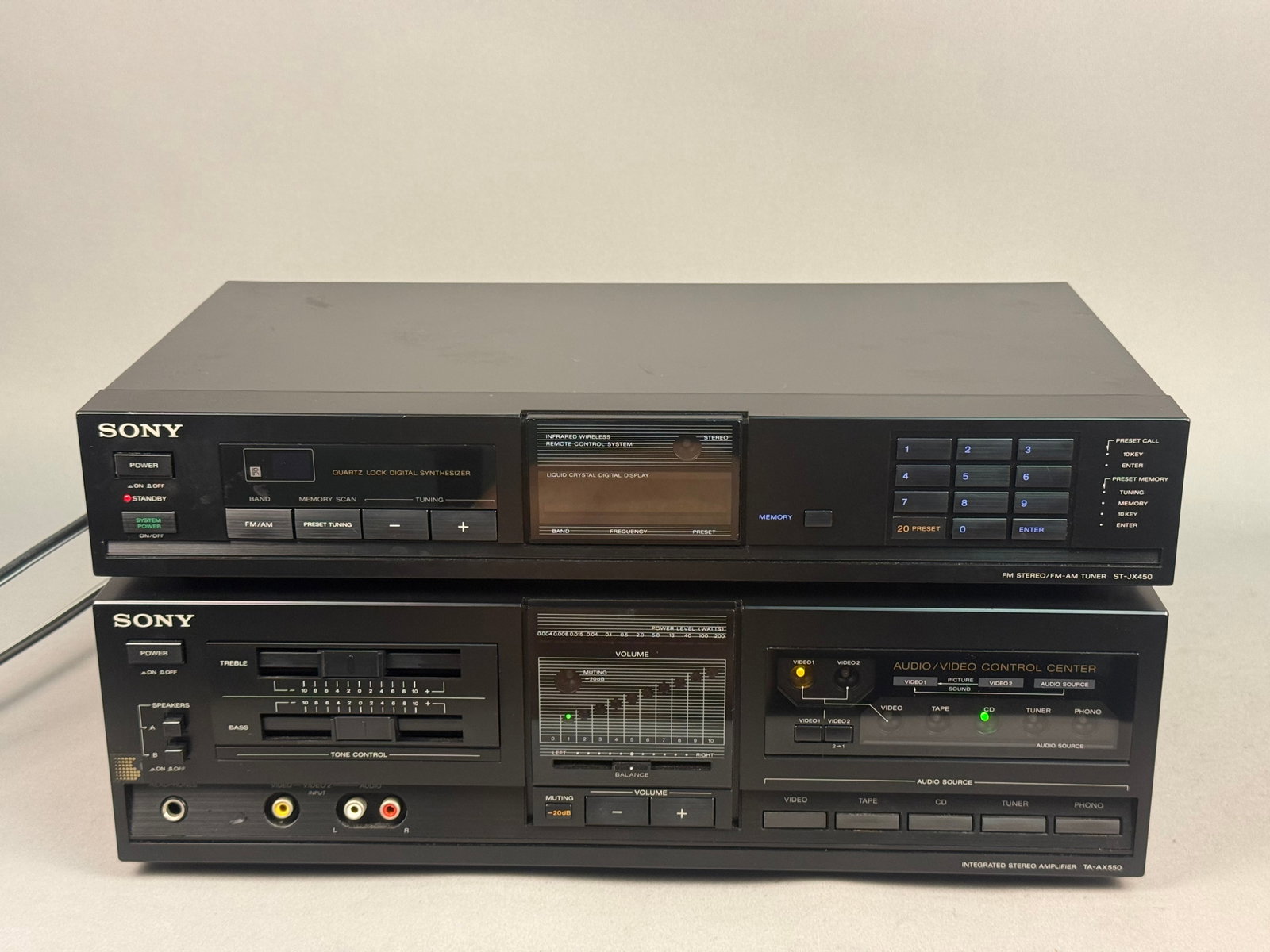 Sony TA-AX550 Integrated Amplifier & Tuner: An assembled pair of matching mid-1980s Sony audio components finished in brushed black metal. The set consists of a TA-AX550 integrated stereo amplifier and an ST-JX450 quartz lock digital