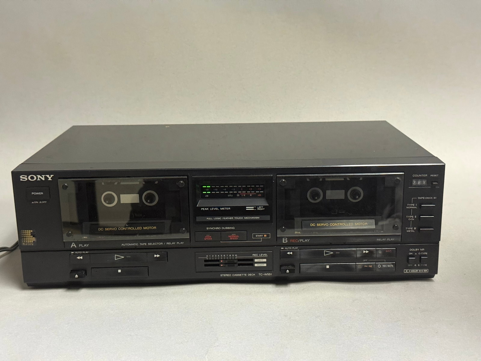 Sony TC-W551 Stereo Double Cassette Deck: A vintage Sony stereo double cassette deck, model TC-W551, featuring a black-finished front panel with silver-tone lettering. The unit is designed with a digital LED peak level meter for audio signal