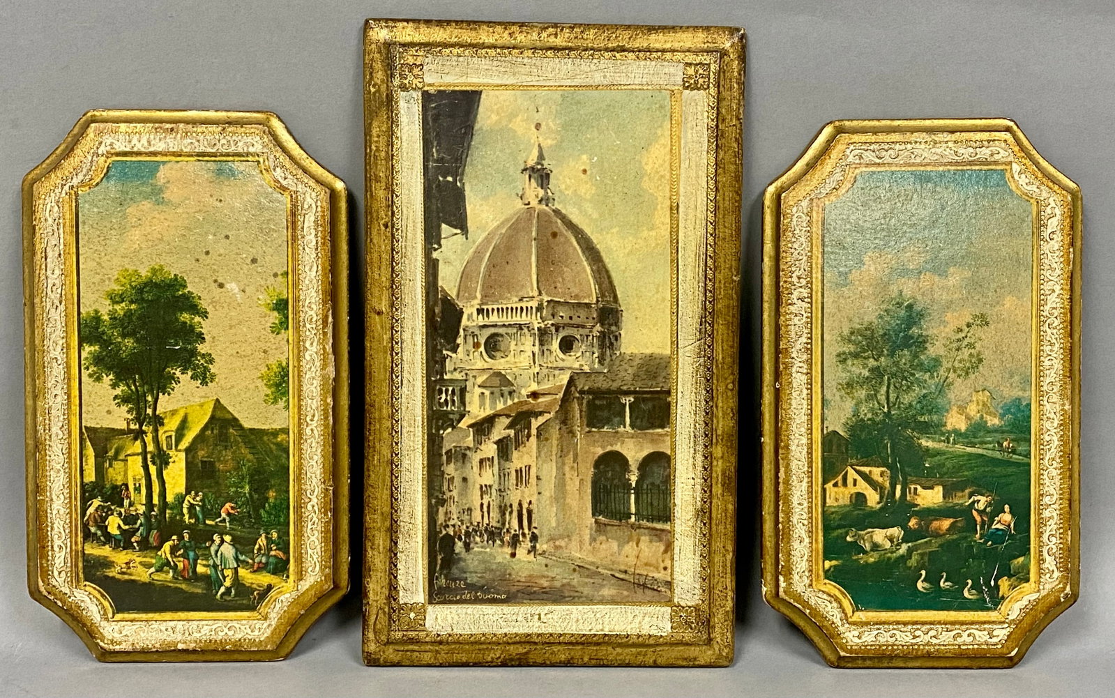 Three Gilded Florentine Wood Plaques: A group of three mid-20th century Italian decorative plaques produced by Florentia and MC Imports. The collection features a rectangular panel depicting a view of the Florence Cathedral, inscribed