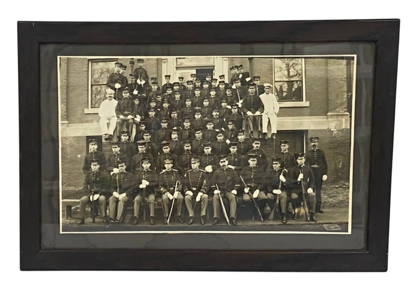 US Army Infantry Company Photograph: A large-format group photograph by O.W. Waterman of Chicago depicting an infantry company posed before a Post Exchange office. The unit is shown in M1902 dress uniforms with crossed-rifle insignia,