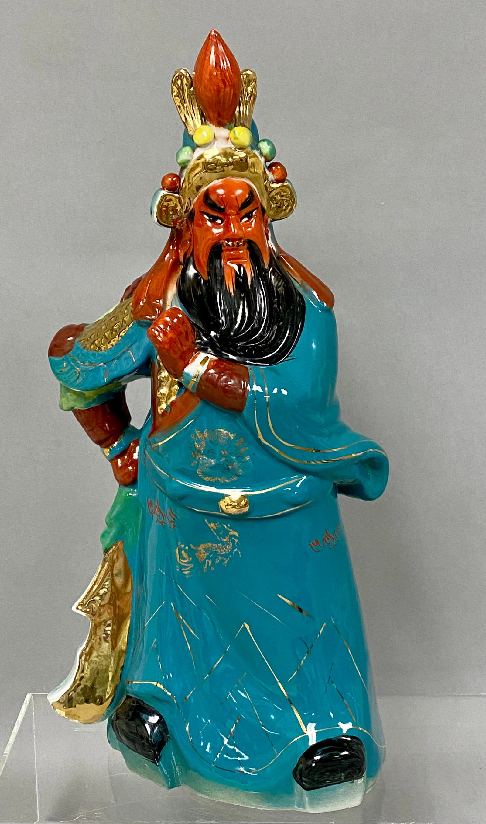 Large Chinese Porcelain Guan Yu Figurine: This molded porcelain figurine represents the deified general Guan Yu, also known as Guan Gong, in a standing martial pose. The figure is decorated in vibrant turquoise glazes with overglaze gold