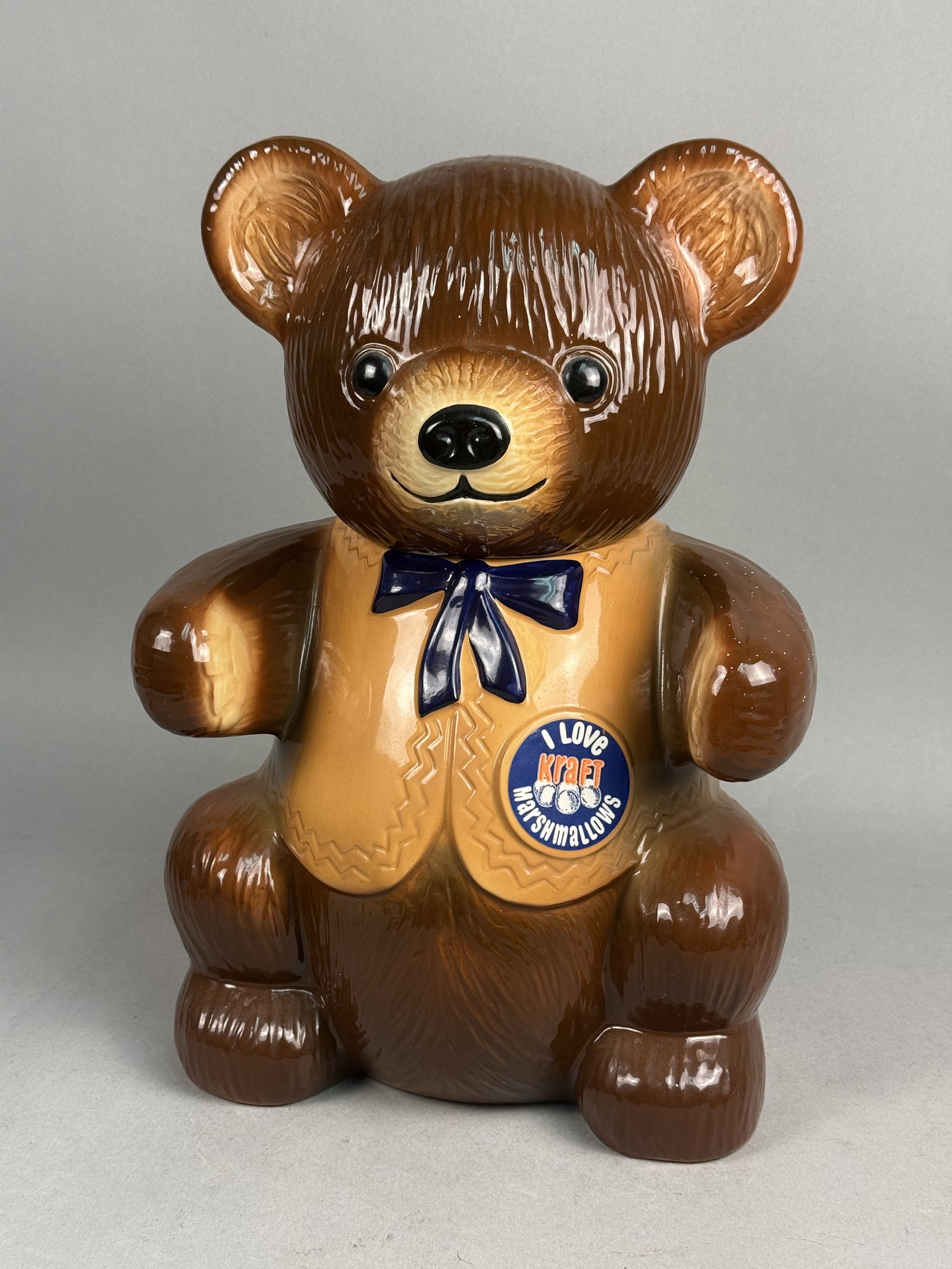 Regal China Kraft Marshmallows Ceramic Cookie Jar: A vintage American ceramic advertising cookie jar produced for Kraft Inc., modeled in the form of a seated teddy bear named T. Bear. The piece features a dark brown textured glaze simulating fur, a