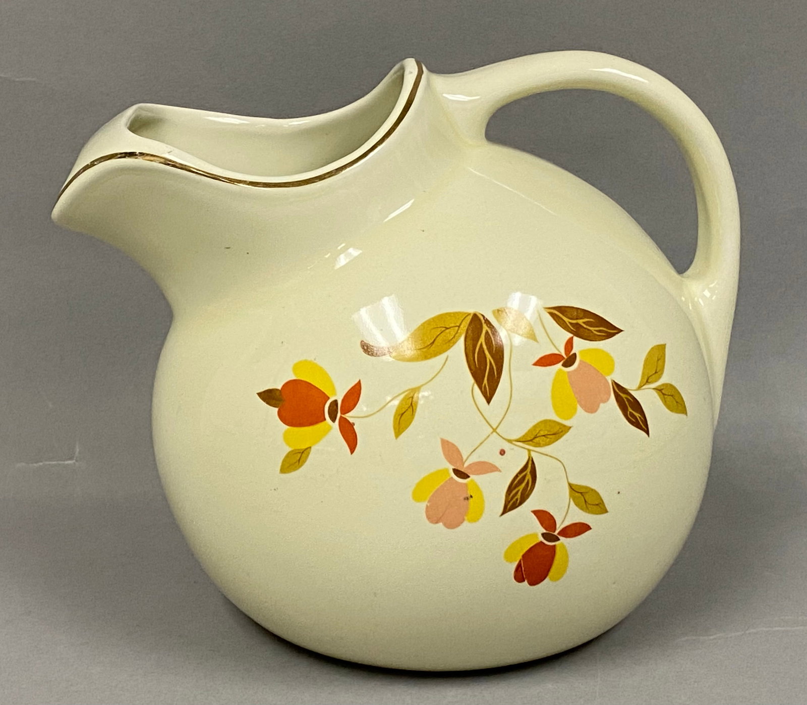Hall Jewel Tea Autumn Leaf Pitcher: This ball-shaped pitcher was produced by the Hall China Company in the Autumn Leaf pattern for the Jewel Tea Company. It features a vitreous china body with a transfer-printed floral design in