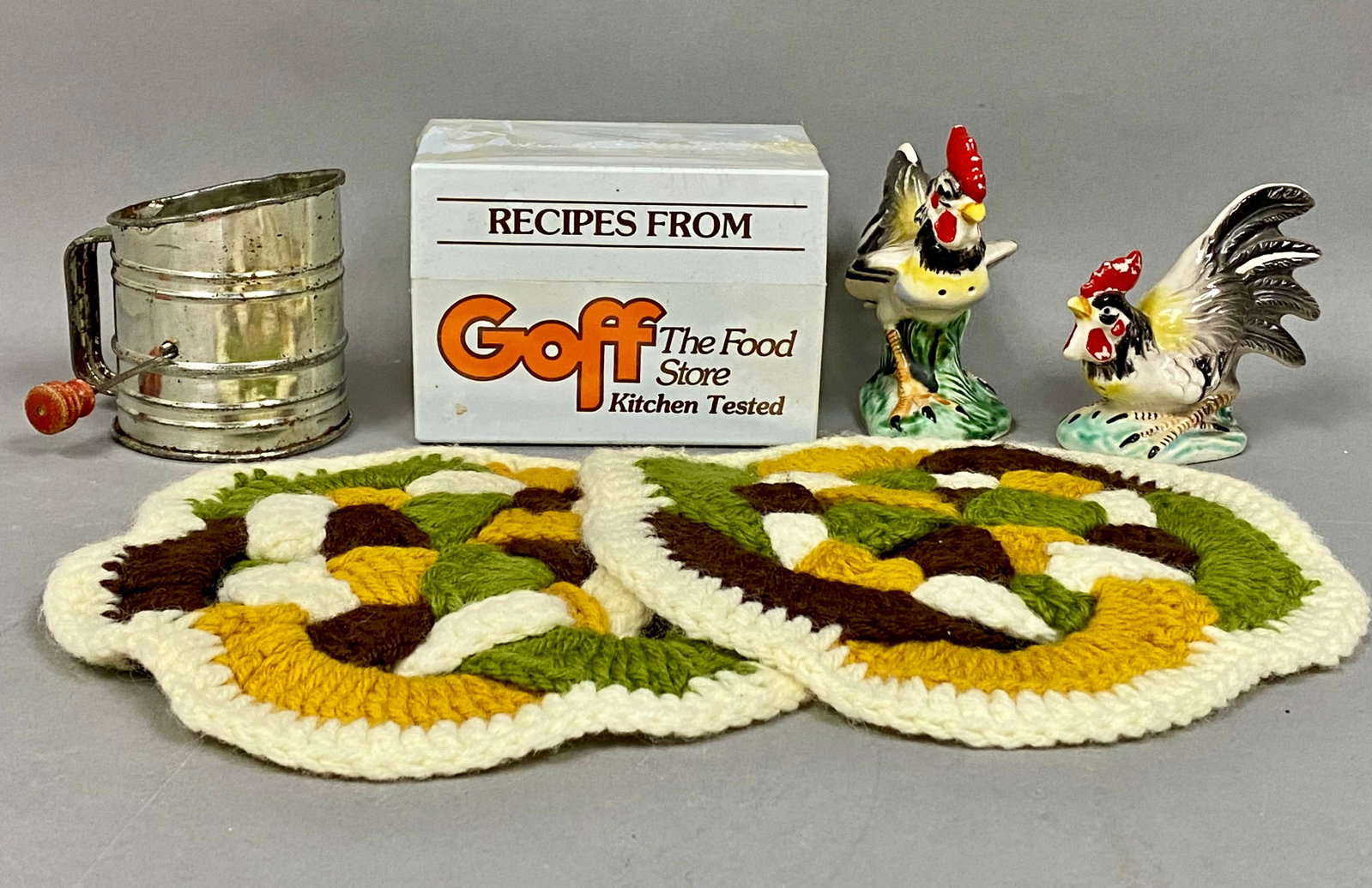 Goff Recipe Box and Kitchenware Assortment: This collection includes a white plastic recipe box with Goff The Food Store advertising and a metal hand-cranked sifter featuring a red wooden handle. The group is further composed of two Japanese