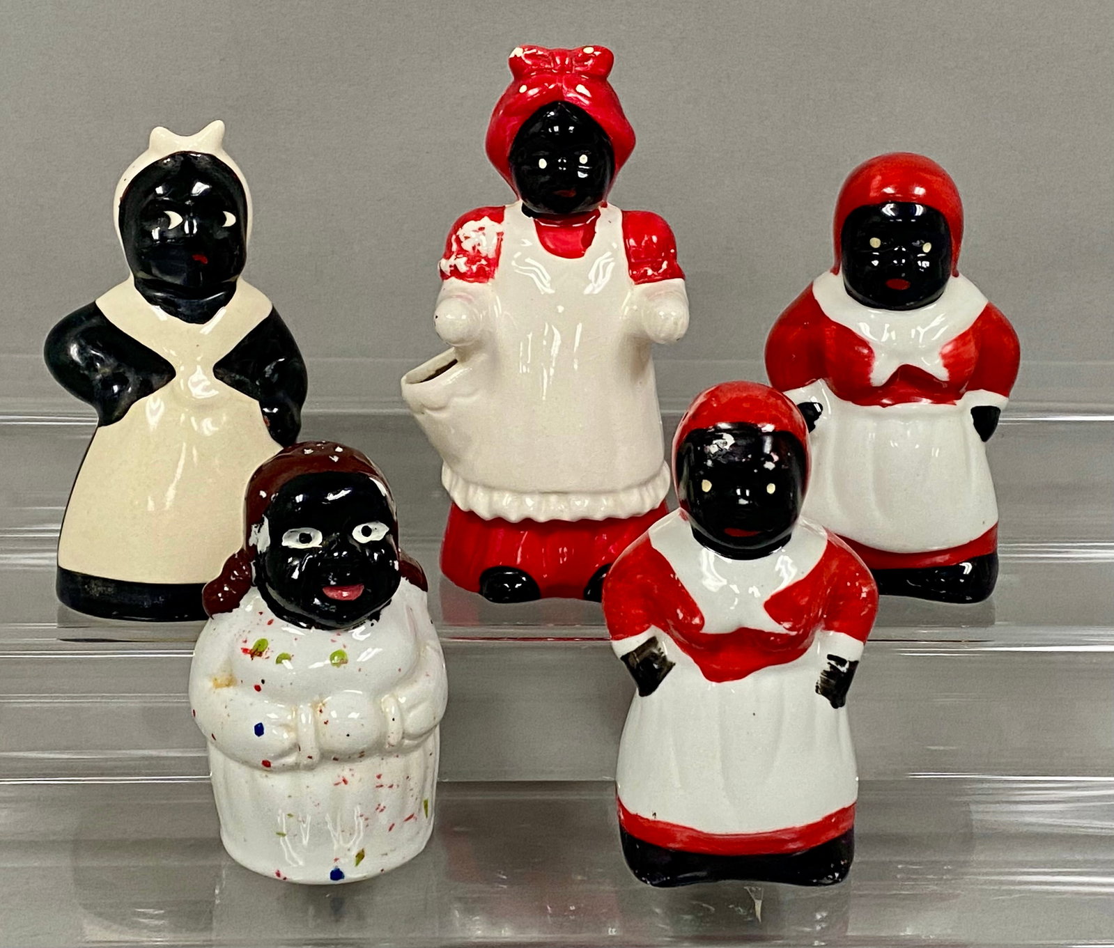 5 Black Americana Ceramic Figurine Assortment: An assortment of vintage glazed ceramic kitchenware figurines in the Black Americana style, depicting Mammy characters. The group includes various forms including several salt and pepper shakers and