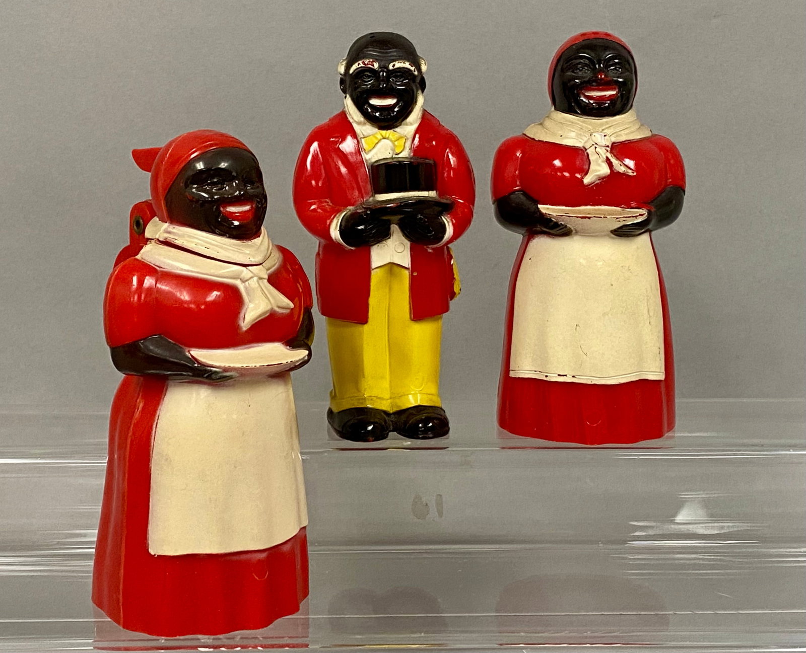 F. & F. Plastic Aunt Jemima Kitchenware Trio: A trio of vintage molded plastic promotional kitchen items comprising one Aunt Jemima syrup pitcher and a salt and pepper shaker set featuring Aunt Jemima and Uncle Mose. The figures are rendered in h