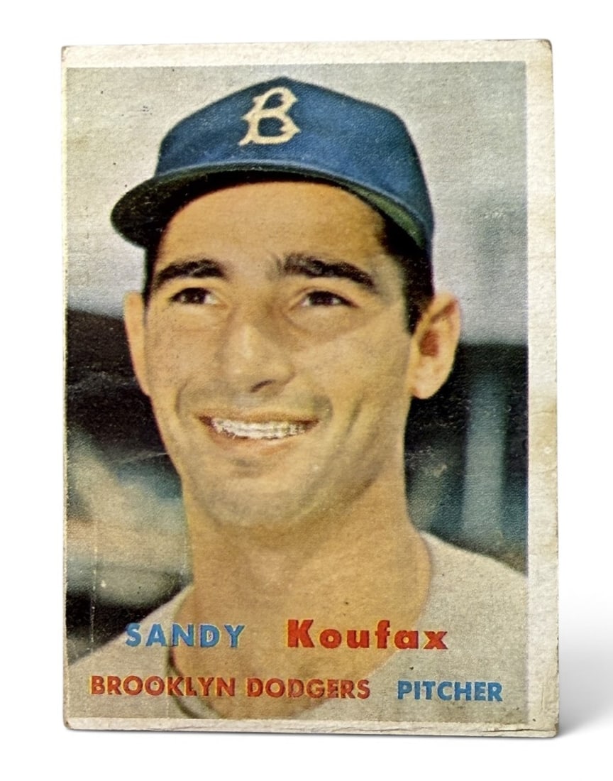 1957 Topps #302 Sandy Koufax Baseball Card: This 1957 Topps baseball card features Brooklyn Dodgers pitcher Sandy Koufax, identified on the reverse as Sanford Koufax. The front displays a color portrait photograph with the player's name in blue