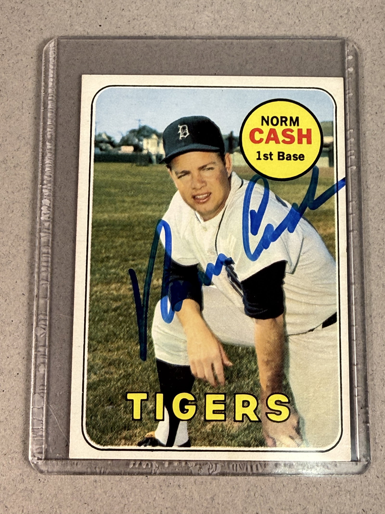 Topps 1969 Norm Cash Signed Baseball Card: A vintage 1969 Topps baseball trading card, number 80, featuring Detroit Tigers first baseman Norm Cash. The front surface is hand-signed in blue marker with a bold signature reading Norm Cash across 