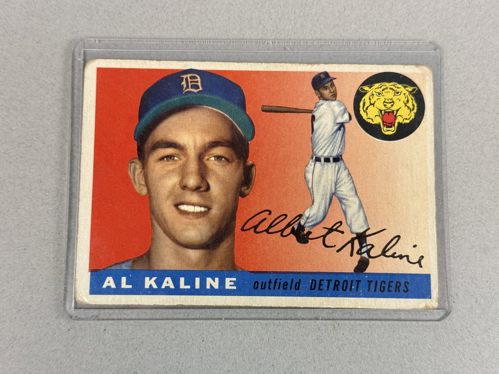 1955 Topps Al Kaline Baseball Card: A 1955 Topps Al Kaline baseball card, number 4, for the Detroit Tigers. This vintage trading card is designed in a horizontal format with a vibrant orange background featuring a colorized portrait and
