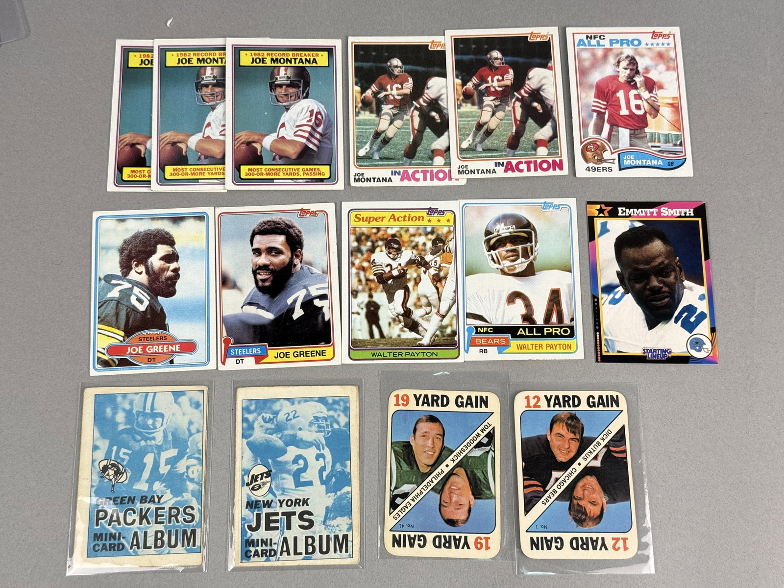 Topps & Kenner Vintage Football Trading Cards: An assortment of vintage NFL trading cards featuring Hall of Fame players including Joe Montana, Walter Payton, Joe Greene, Emmitt Smith, and Dick Butkus. The lot includes items from Topps and Kenner,