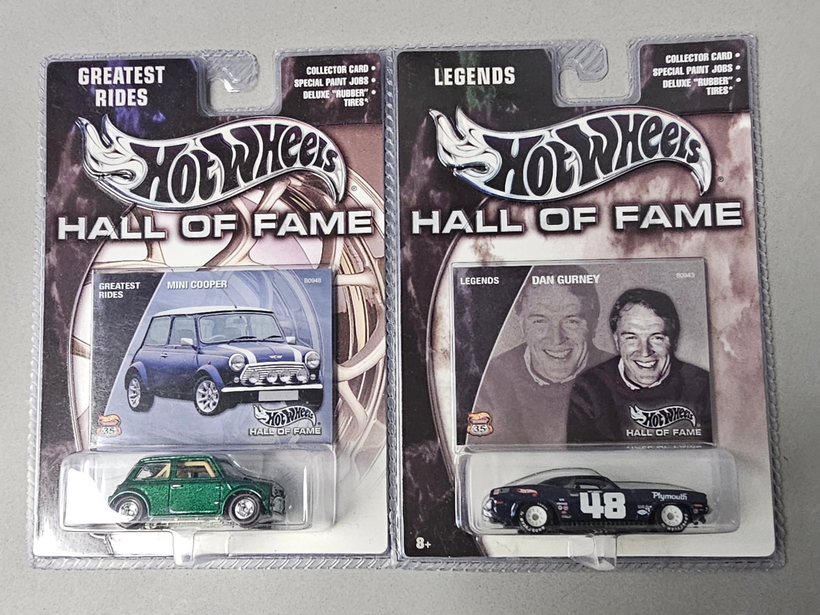 2 Hot Wheels Hall of Fame Die-Cast Cars: An assortment of two factory-sealed Hot Wheels die-cast toy cars from the 35th Anniversary Hall of Fame series. The lot includes one Greatest Rides Mini Cooper finished in metallic green with a white 