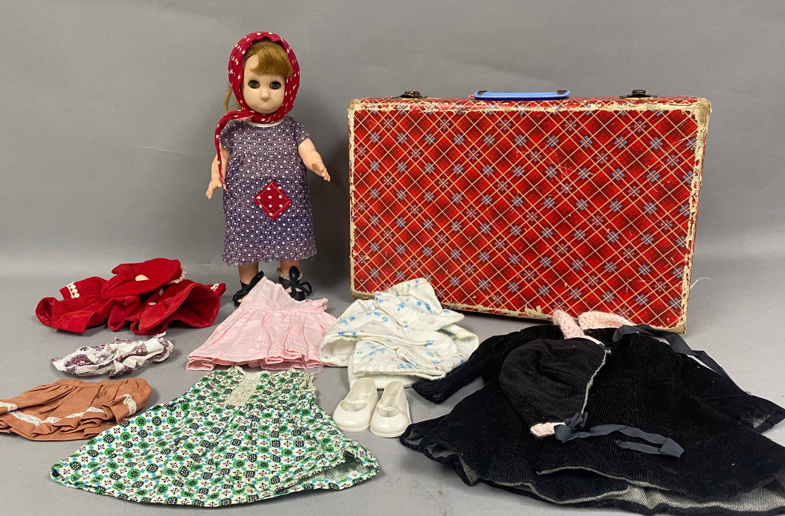 Brookglad Poor Pitiful Pearl Doll & Wardrobe: A vintage jointed doll with a vinyl head and plastic body, identified as Poor Pitiful Pearl by Brookglad. The doll features a stylized face with a wide, close-lipped smile and large green eyes with bl