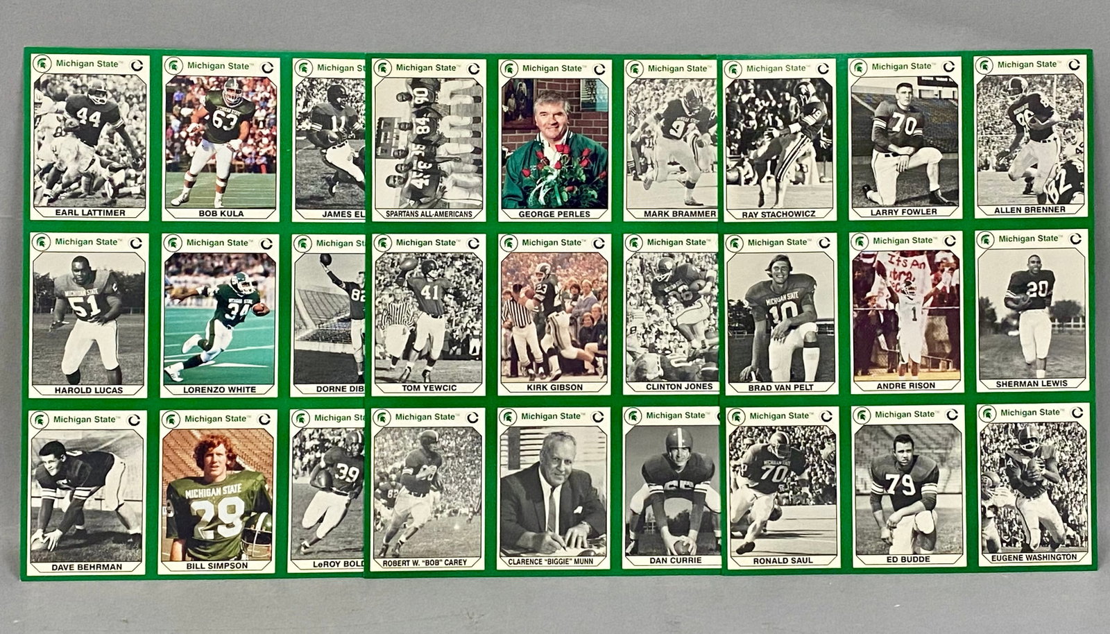 3 1990 Collegiate Collection Michigan State Football Sheets: A set of three uncut nine-card sheets from the 1990 Collegiate Collection Michigan State Spartans football series. Each sheet contains nine individual player and coach cards arranged in a