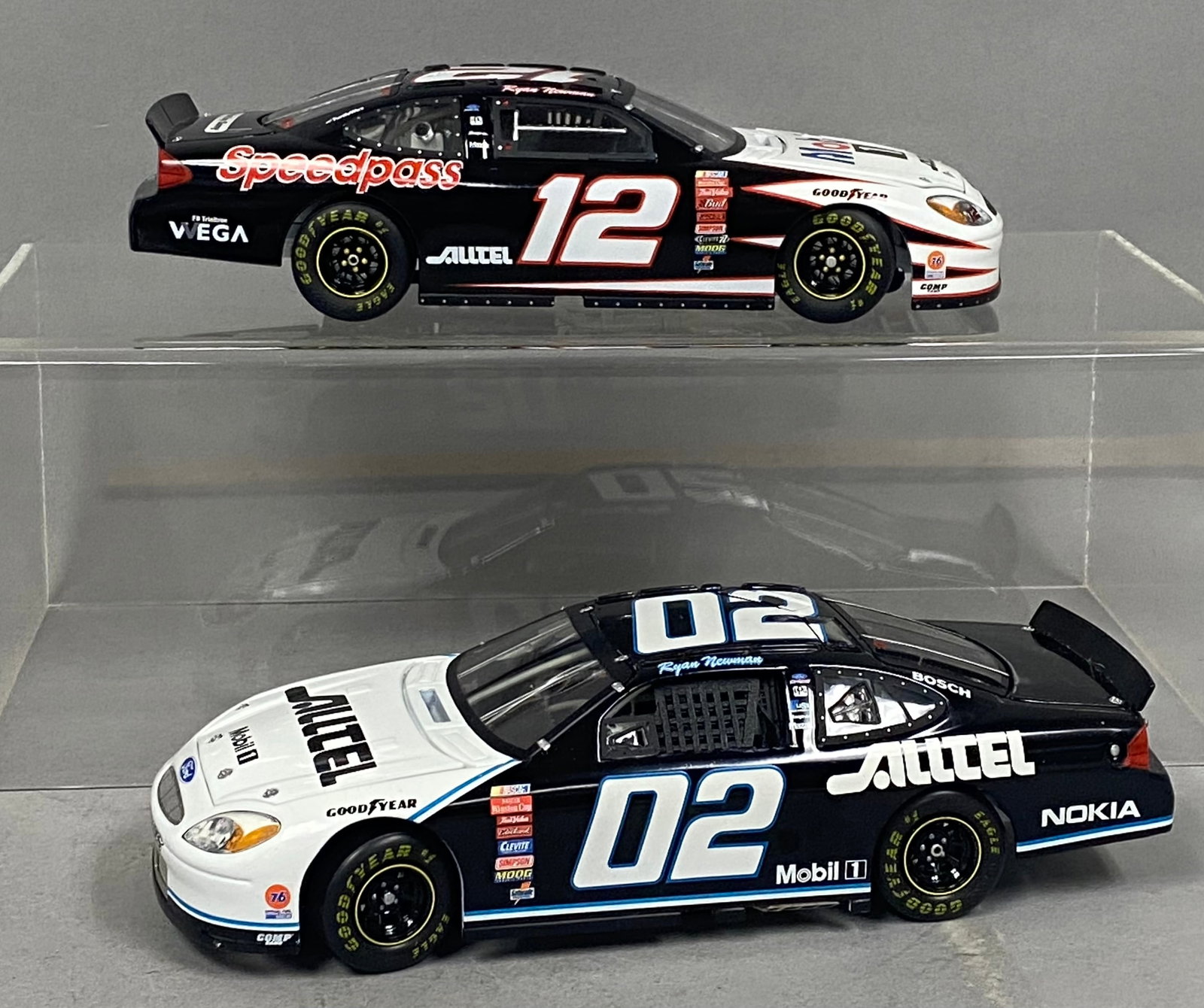 2 Team Caliber Ryan Newman Ford Taurus Models: A pair of 1:24 scale model cars from the Team Caliber Owners Series, depicting Ryan Newman's 2001 #02 Alltel Ford Taurus and 2002 #12 Mobil 1/Alltel Ford Taurus. Both vehicles feature die-cast metal c